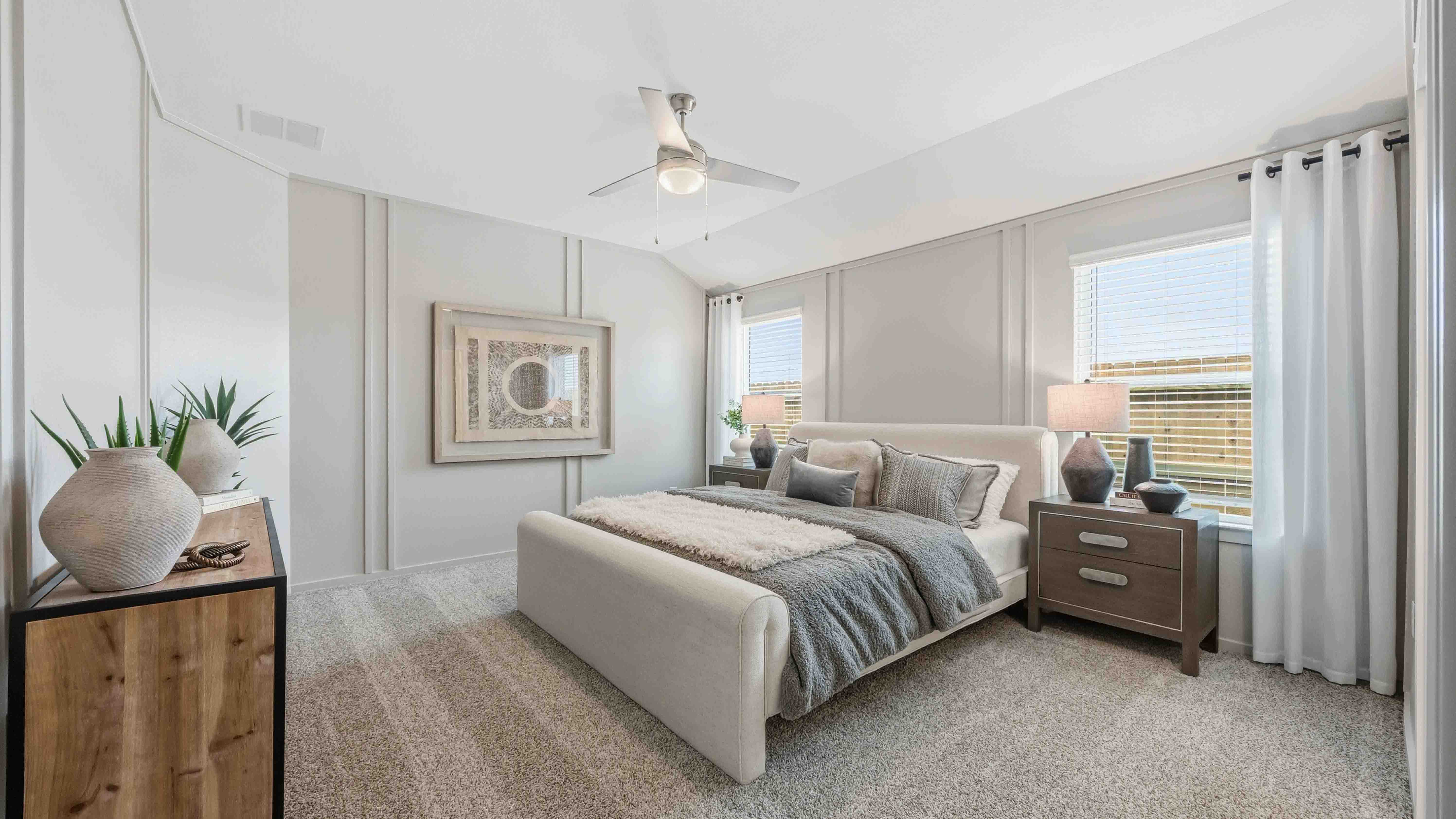 a spacious primary suite comfortably fits a king size bed and additional bedroom furniture
