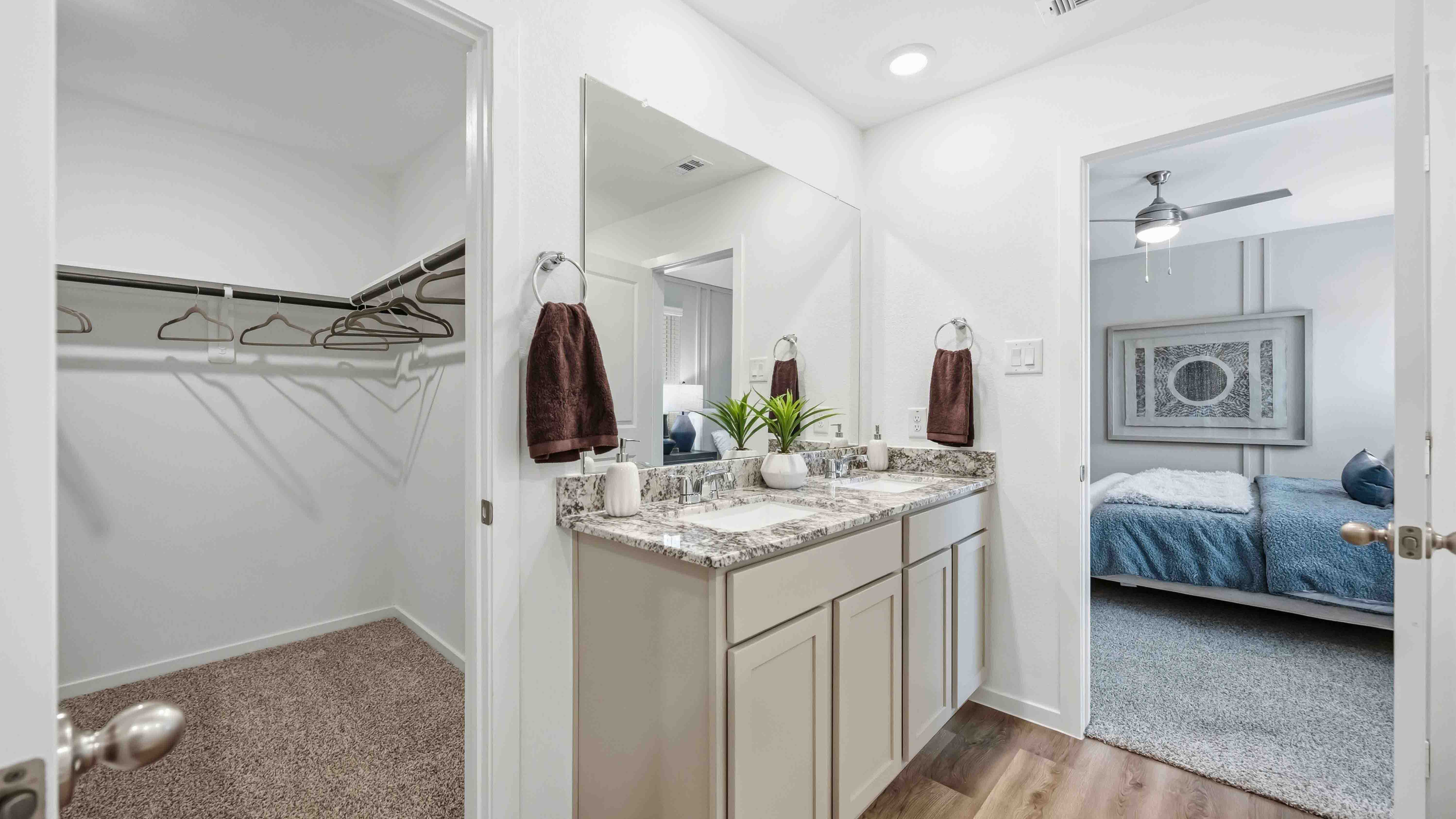 the en-suite primary bathroom has a double vanity and a standing shower