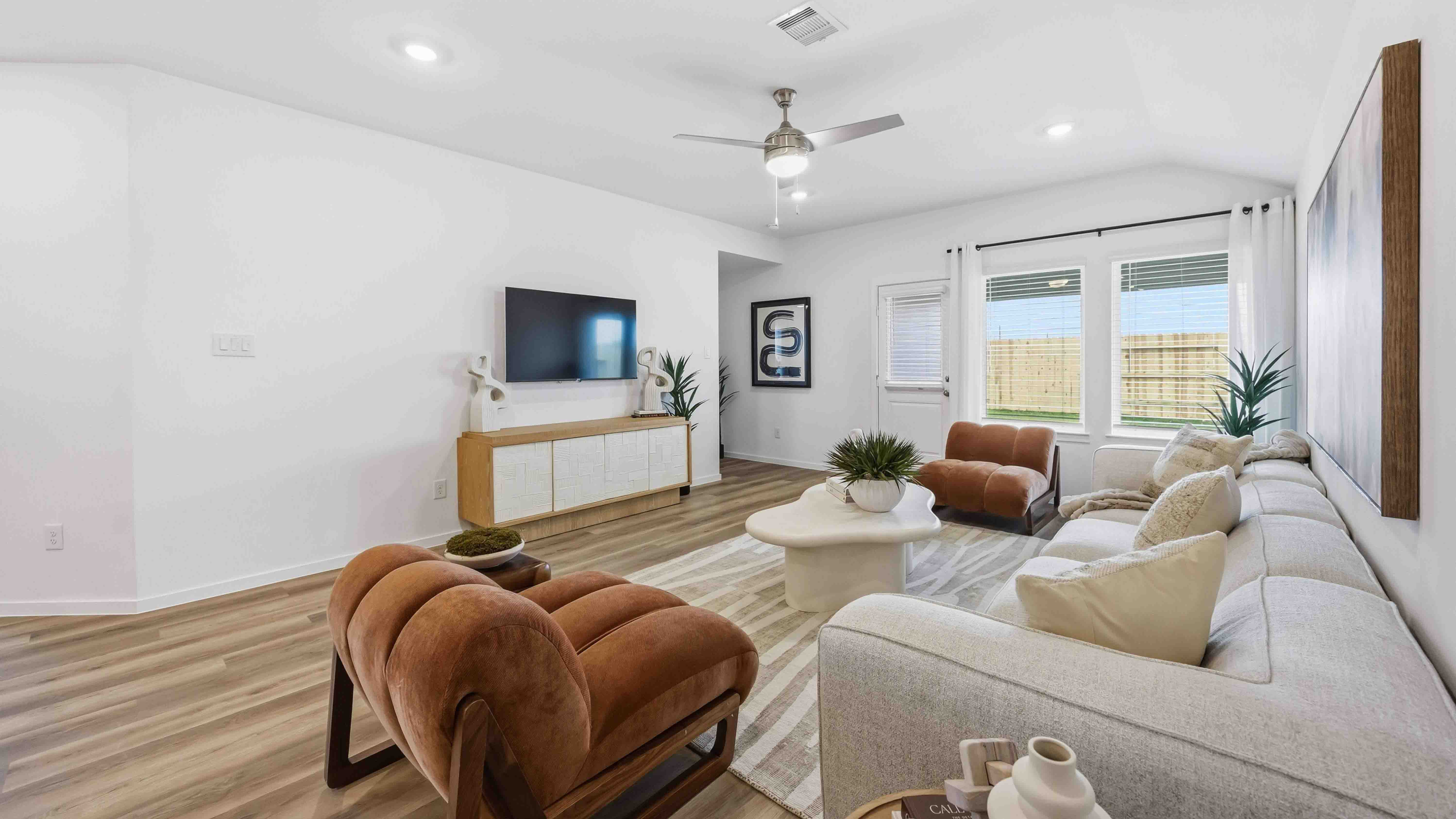 living room area with two large windows to the backyard
