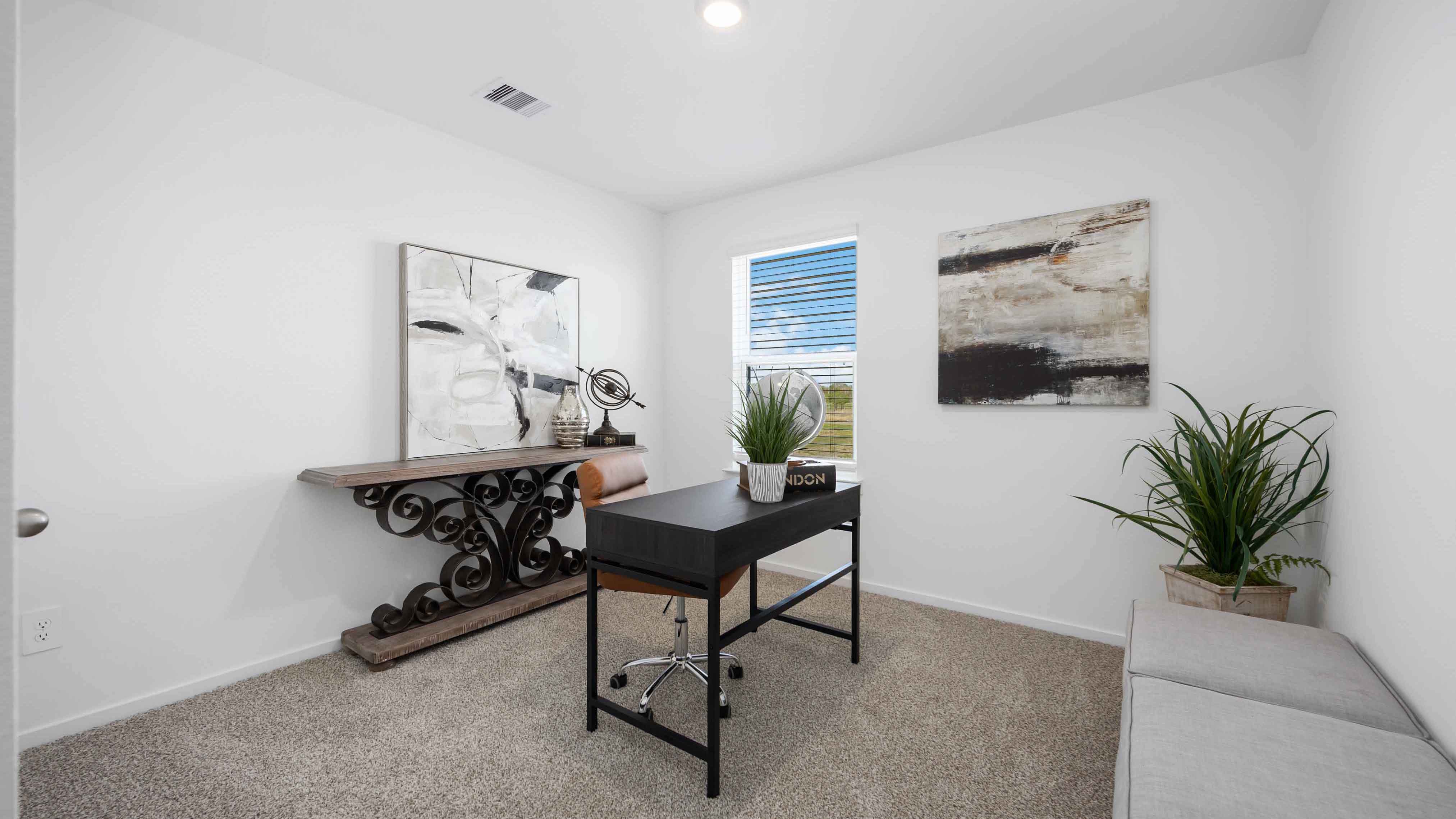 home office/another bedroom has light neutral walls and carpet flooring
