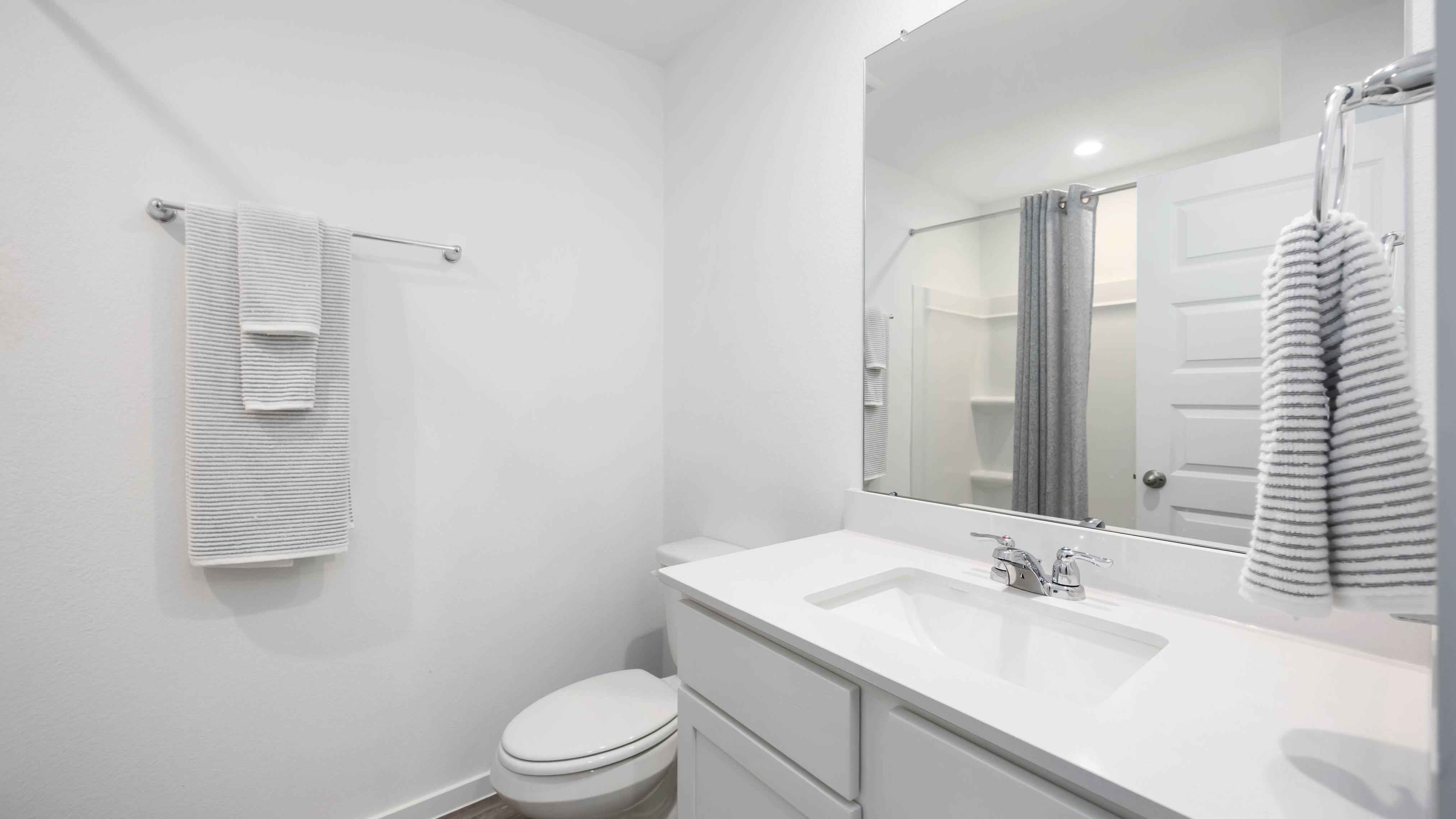 a spacious secondary bathroom with one sink vanity and standing tub