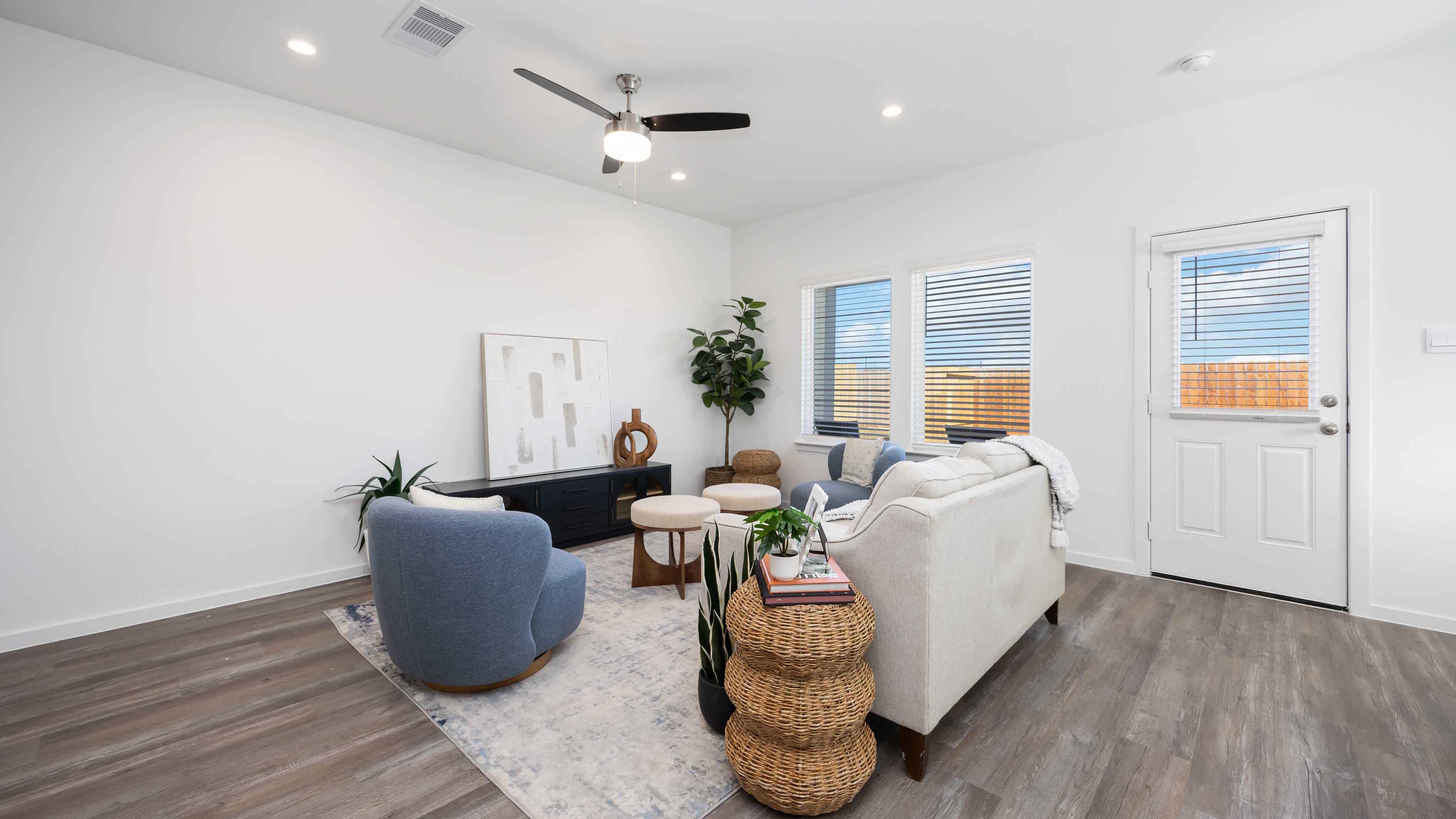 spacious living room with plenty of natural light from windows overlooking the backyard