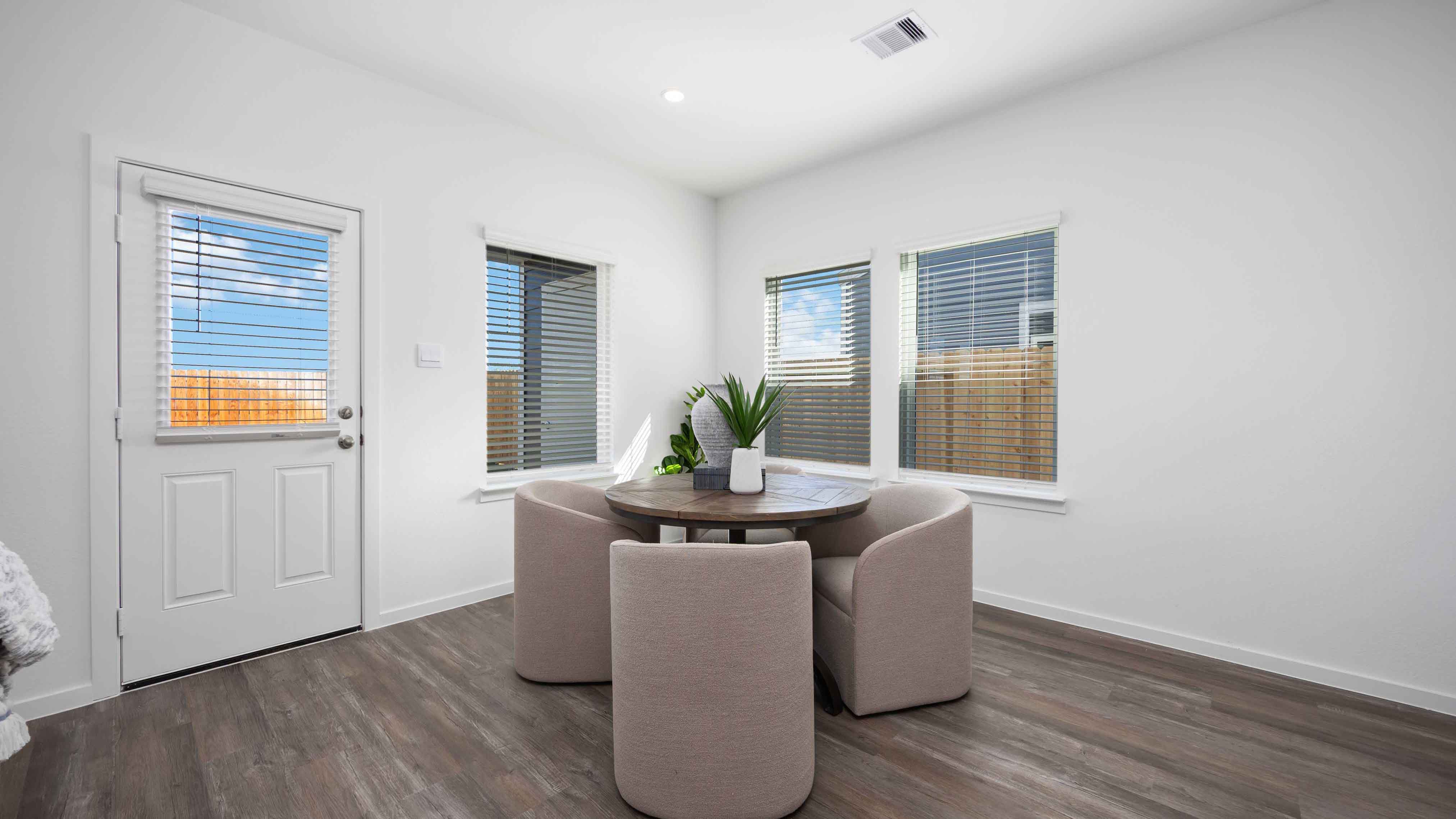 dining area with natural lighting that overlooks the backyard