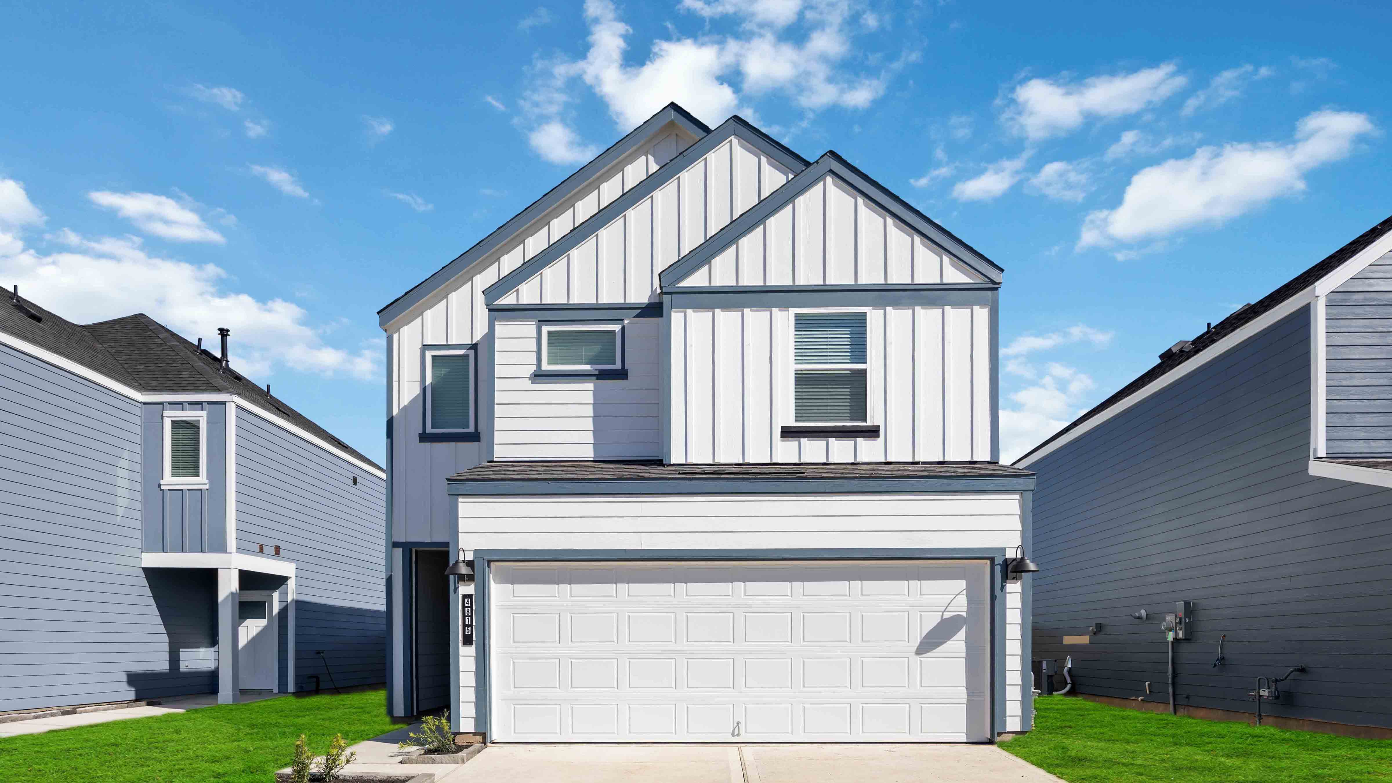 Two-story home with white siding and a two-car garage.
