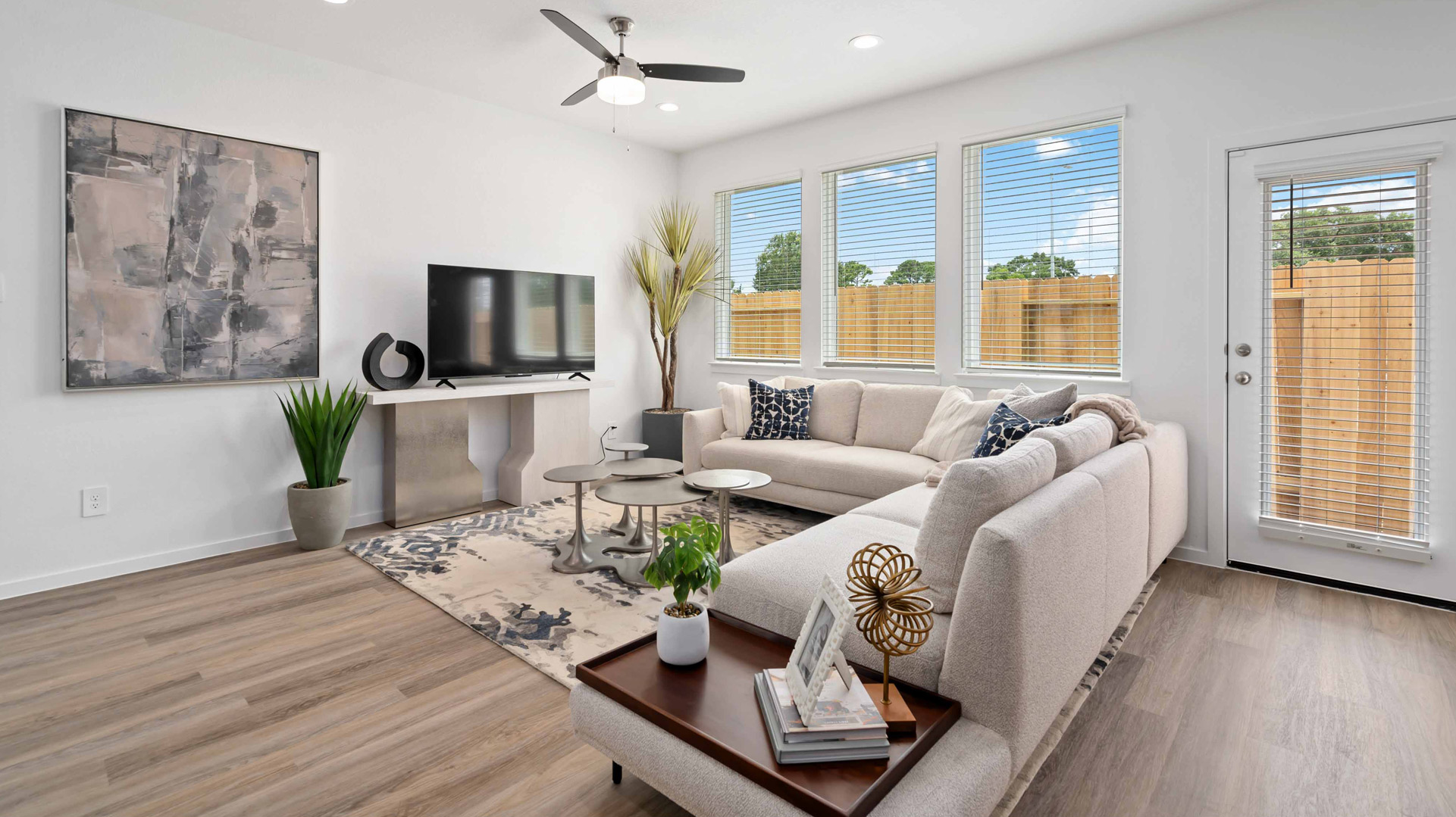 spacious living room with plenty of natural light from windows overlooking the backyard