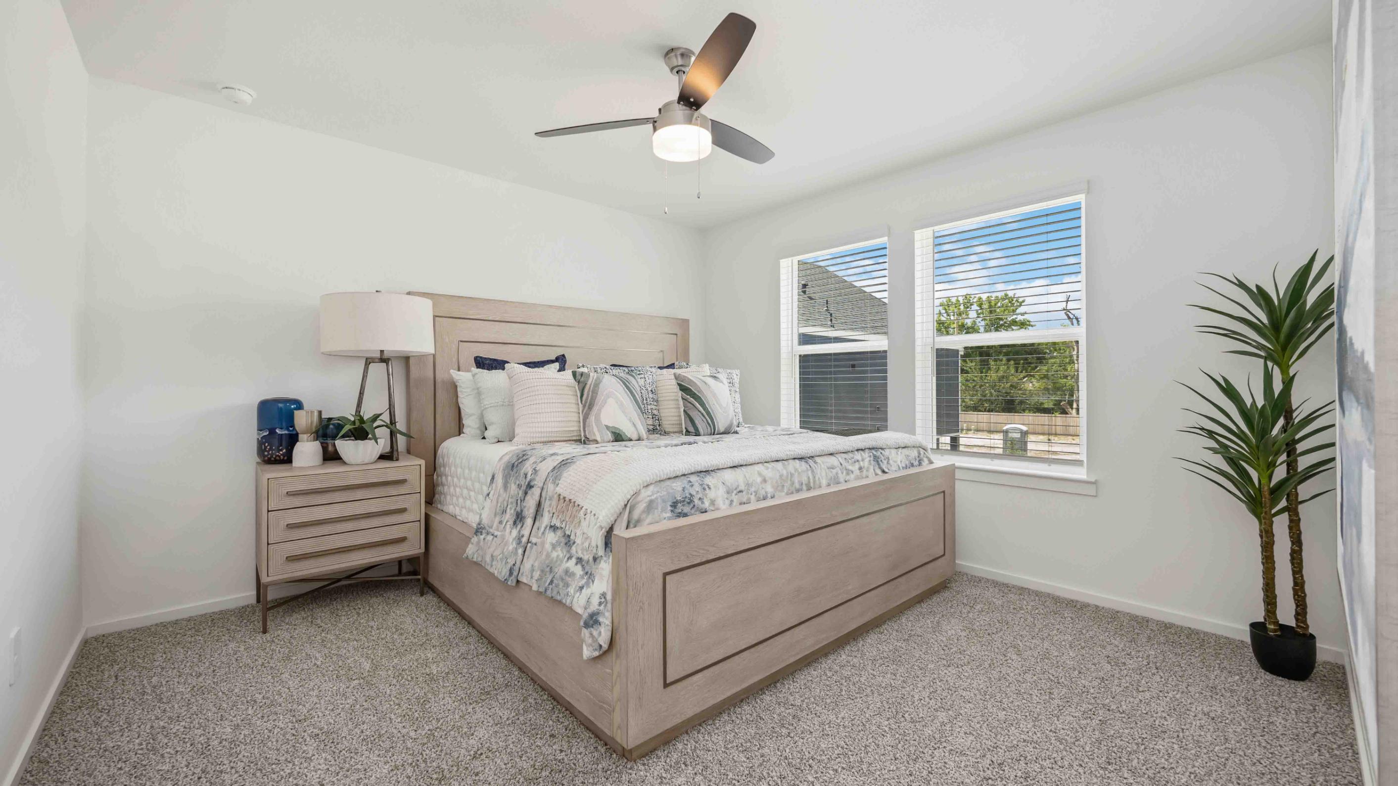 a beautiful and spacious primary suite comfortably fits a king size bed and additional bedroom furniture