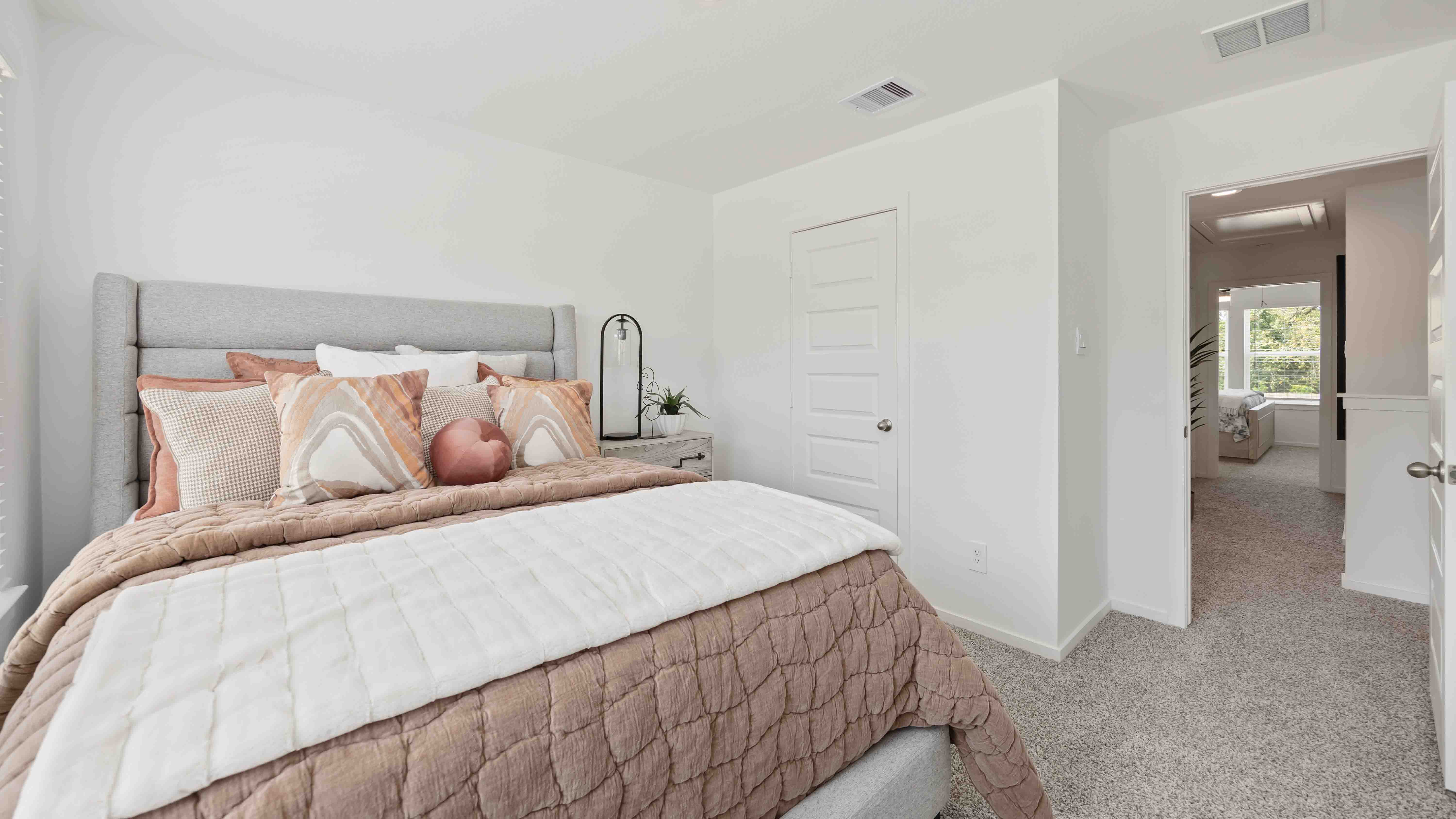 secondary bedrooms have light neutral walls and carpet flooring