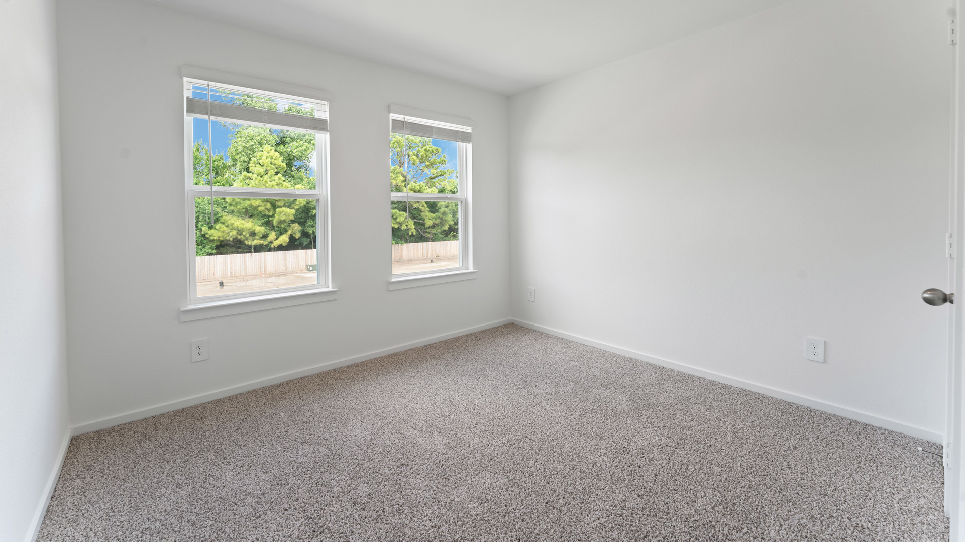 third bedroom has light neutral walls and carpet flooring