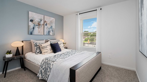 alaia crossing model home secondary bedroom with carpet flooring and tall single window
