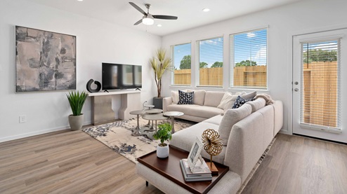 alaia crossing model home living room with ample light from wall of windows