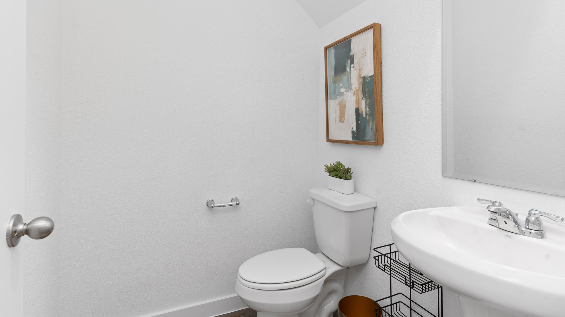 main floor powder bathroom with pedestal sink