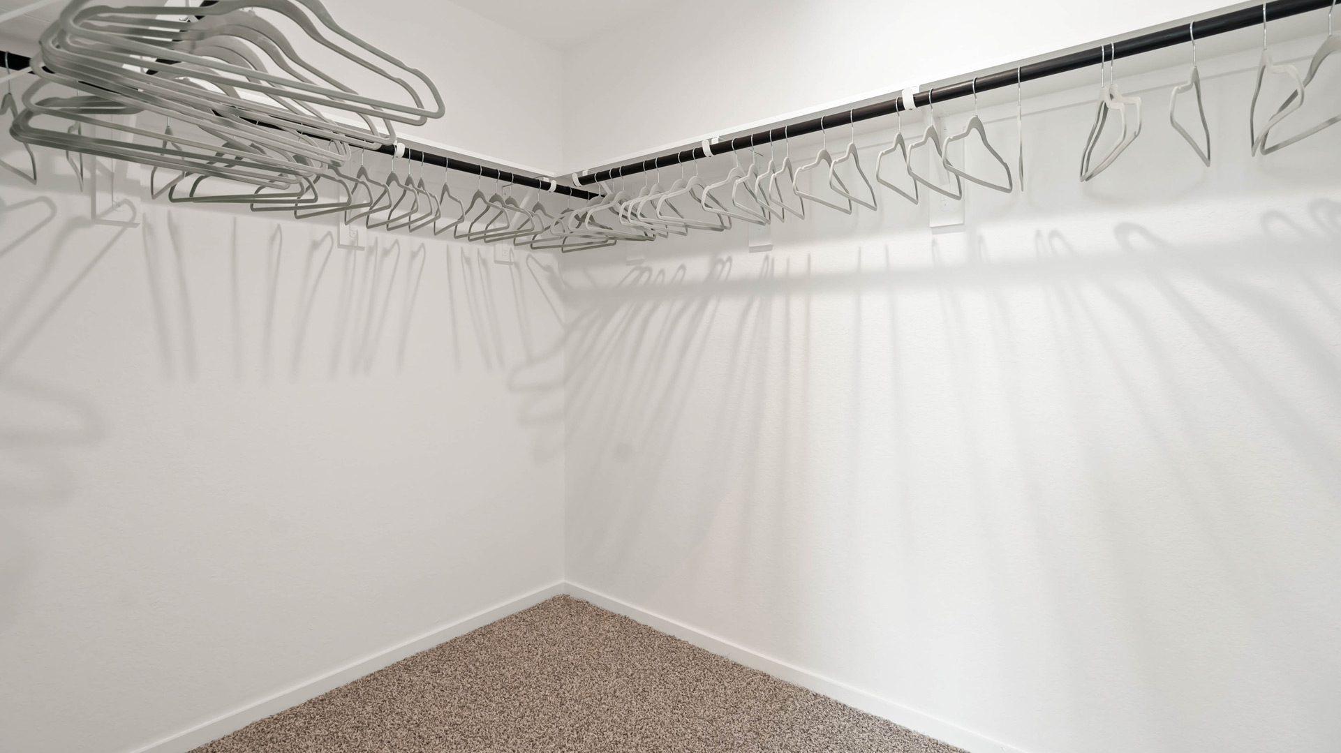 spacious primary closet offers plenty of space for clothing and accessories