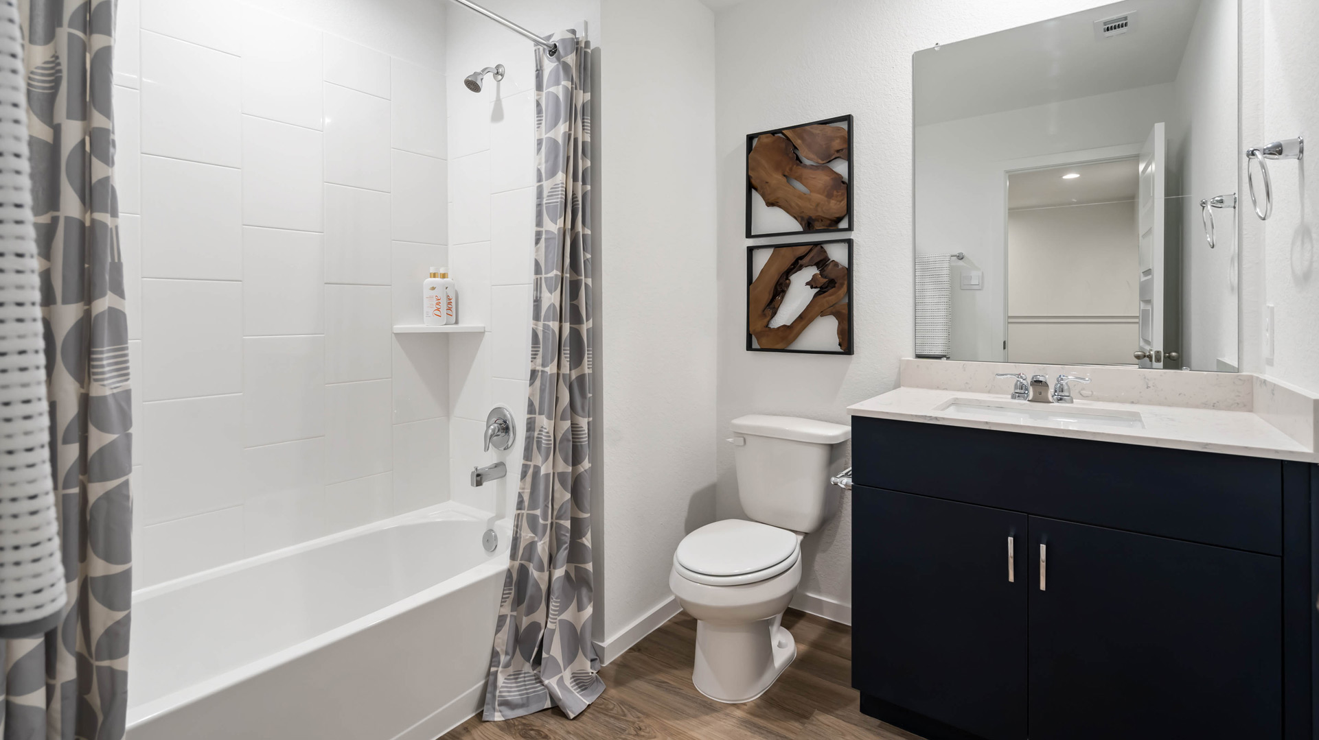 second full bathroom with mirror over single vanity and shower/tub combo