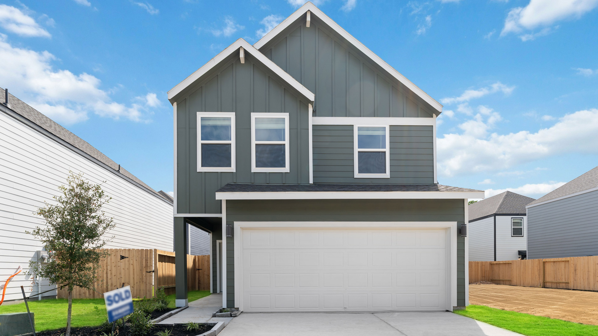 dove plan exterior, a two story home with a two-car garage