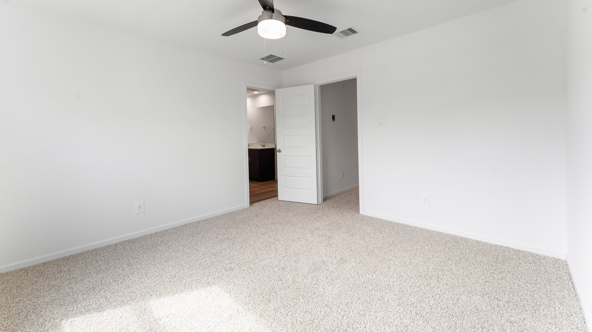 the primary bedroom can comfortably fit a king size bed and additional bedroom furniture