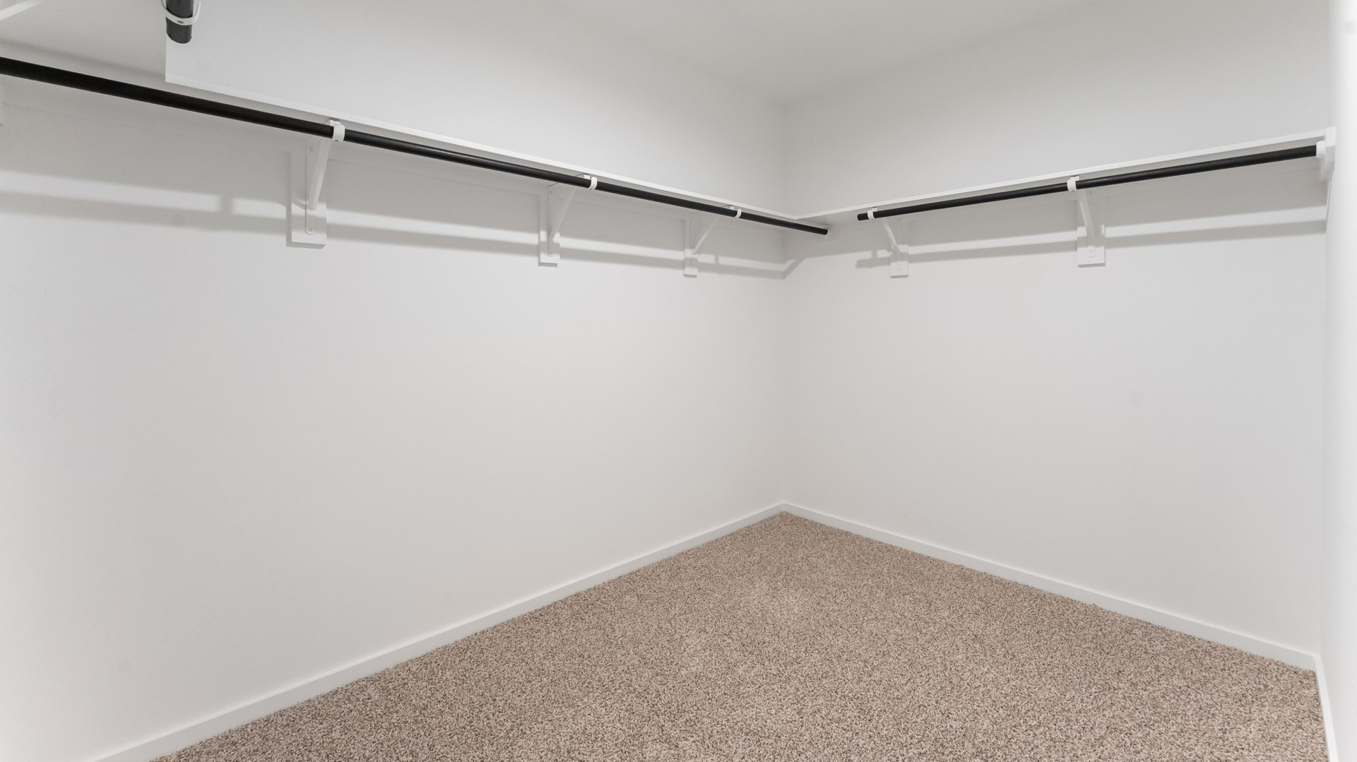 a spacious primary closet is conveniently located off the bathroom and has ample storage room