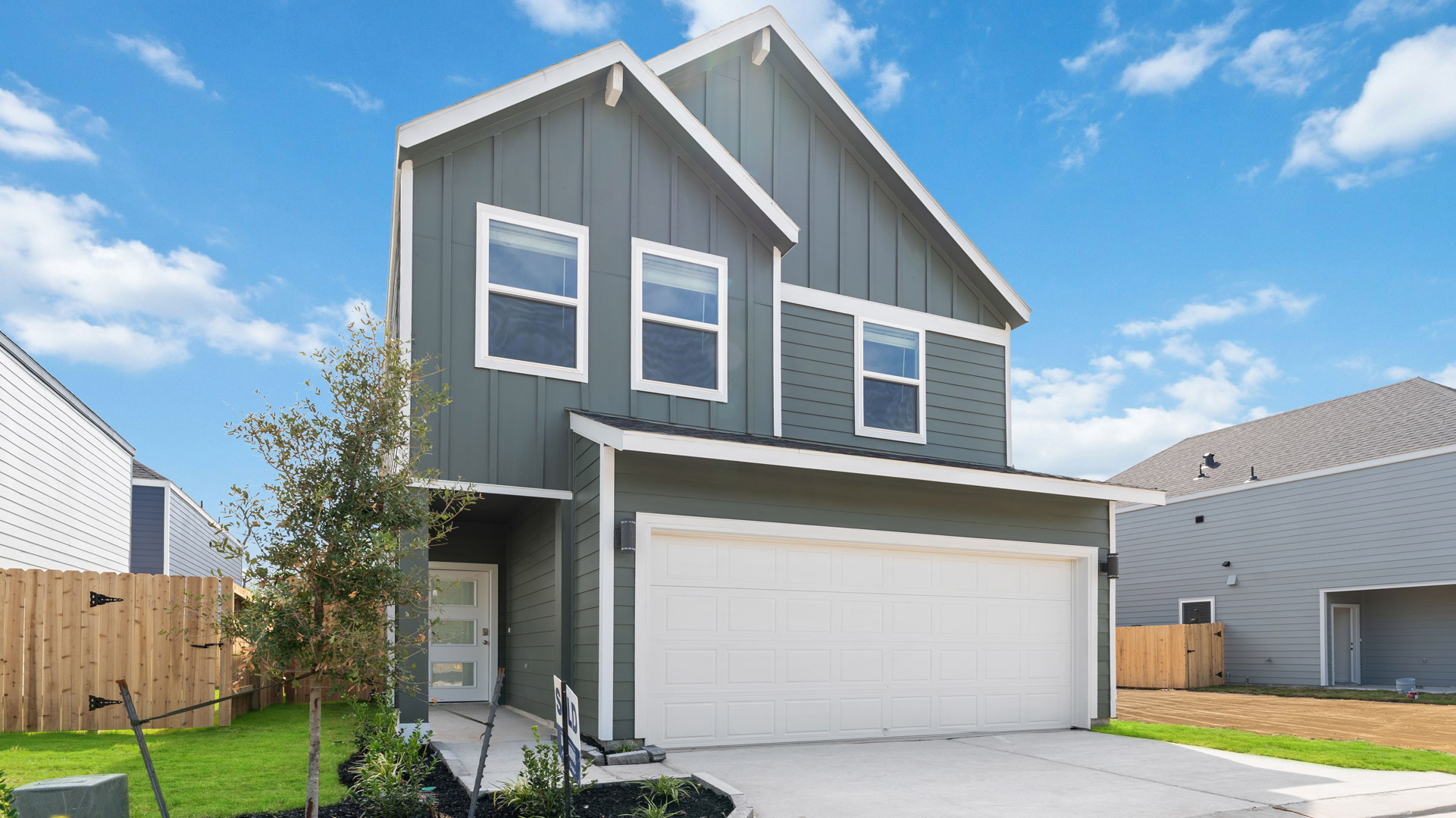 dove plan exterior, a two story home with a two-car garage