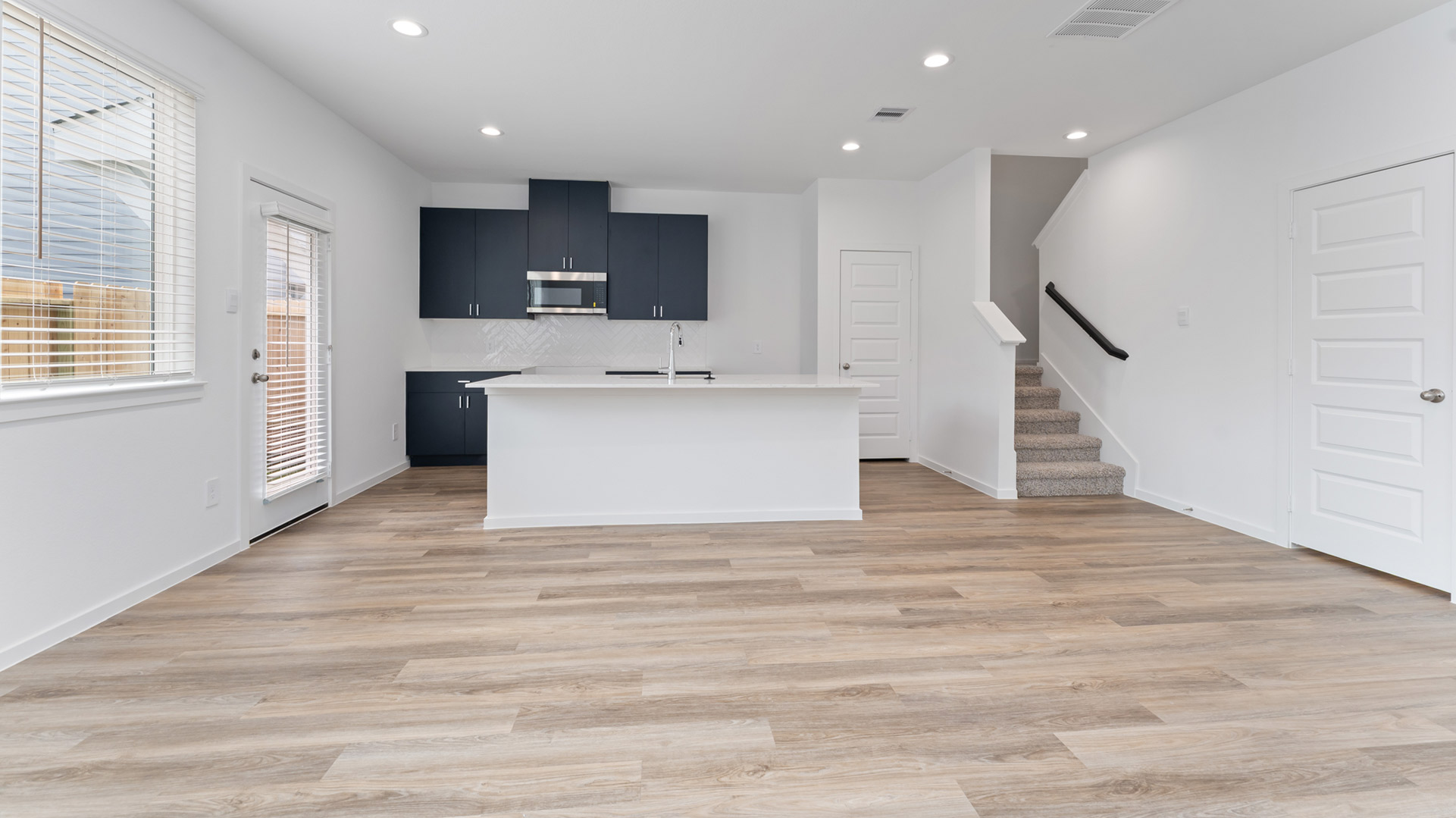 kitchen overlooks all main living areas of the home
