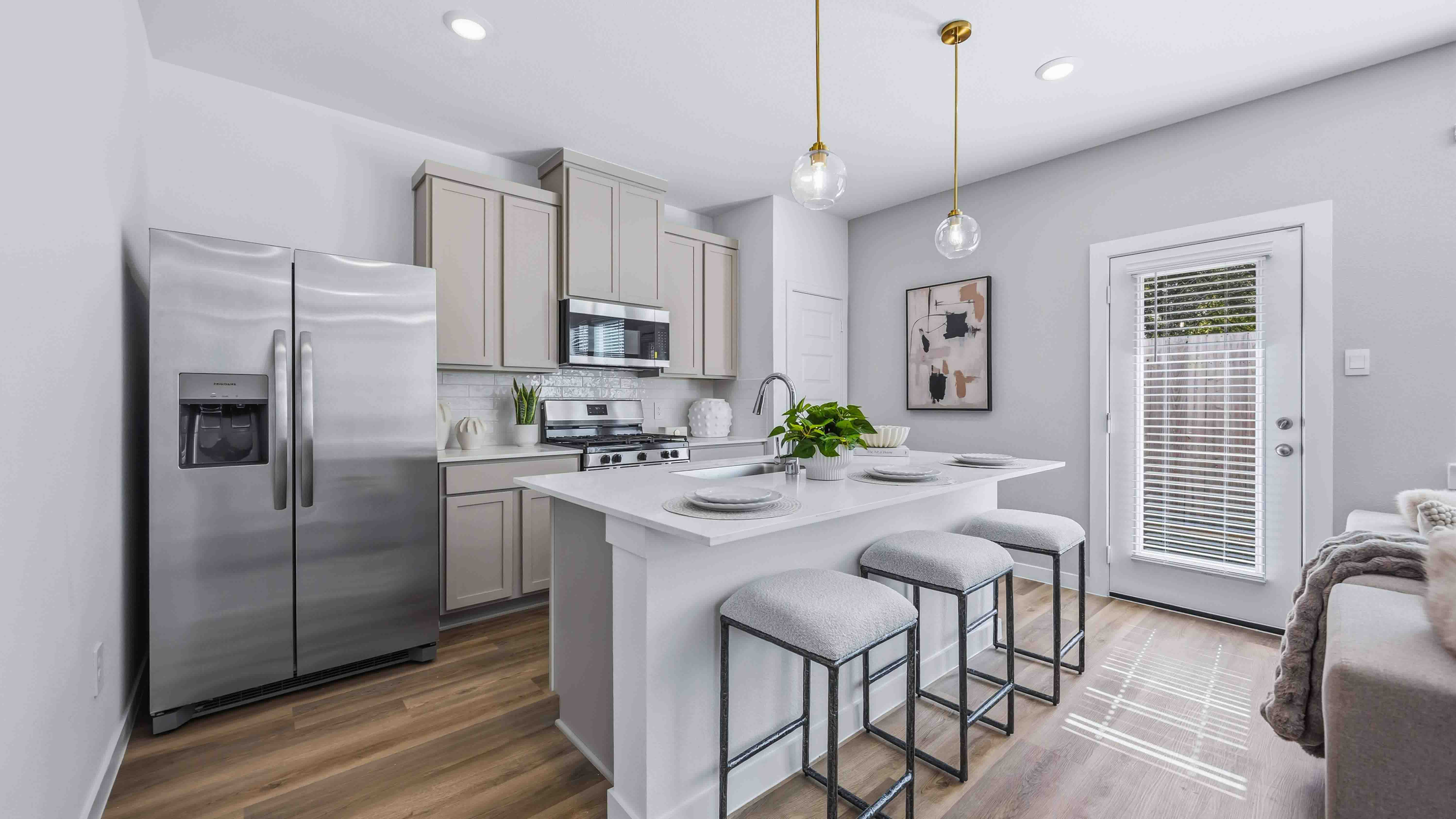 kitchen with light grey cabinets and stainless steel appliances