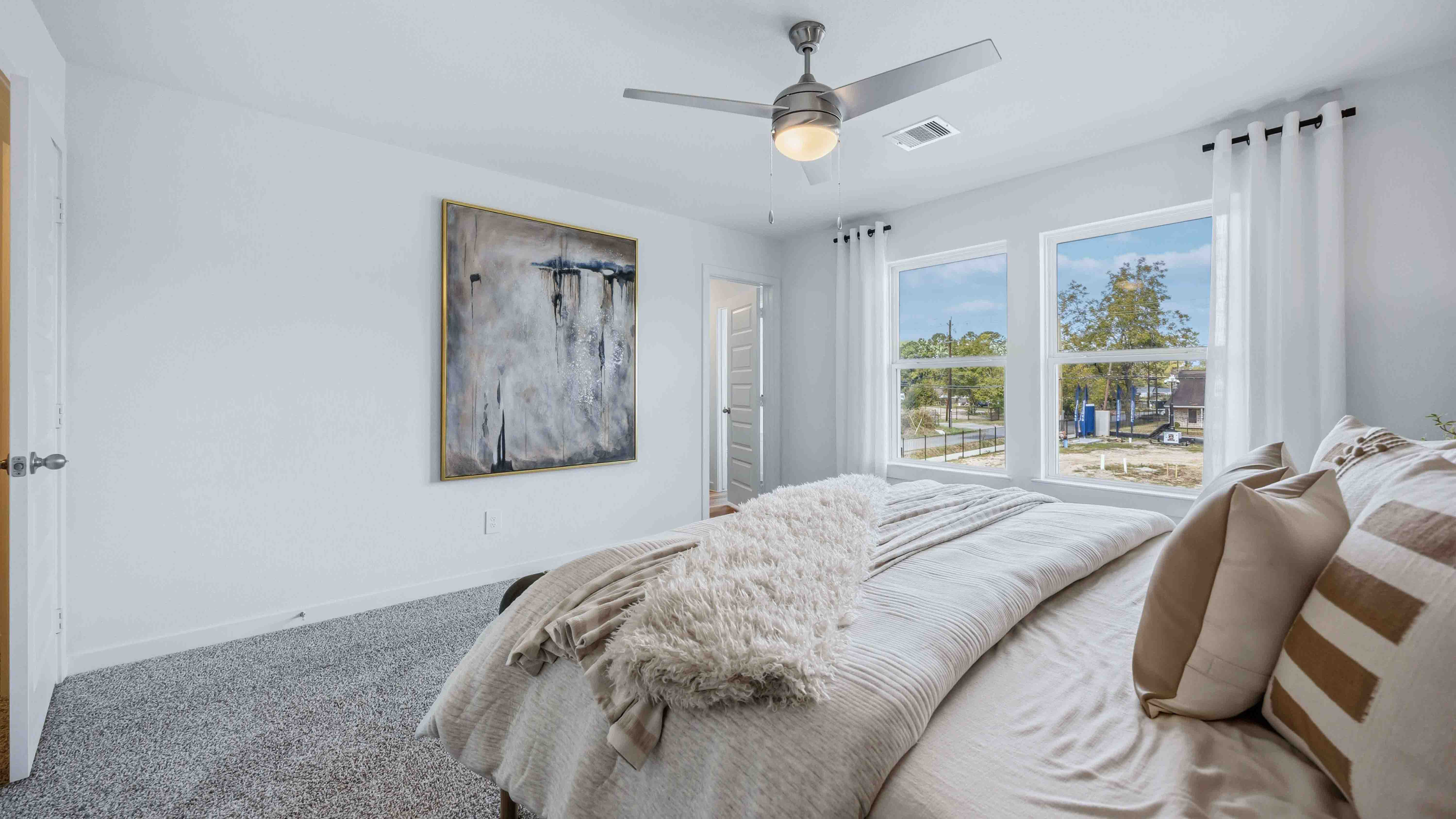 primary bedroom with two large windows for natural light