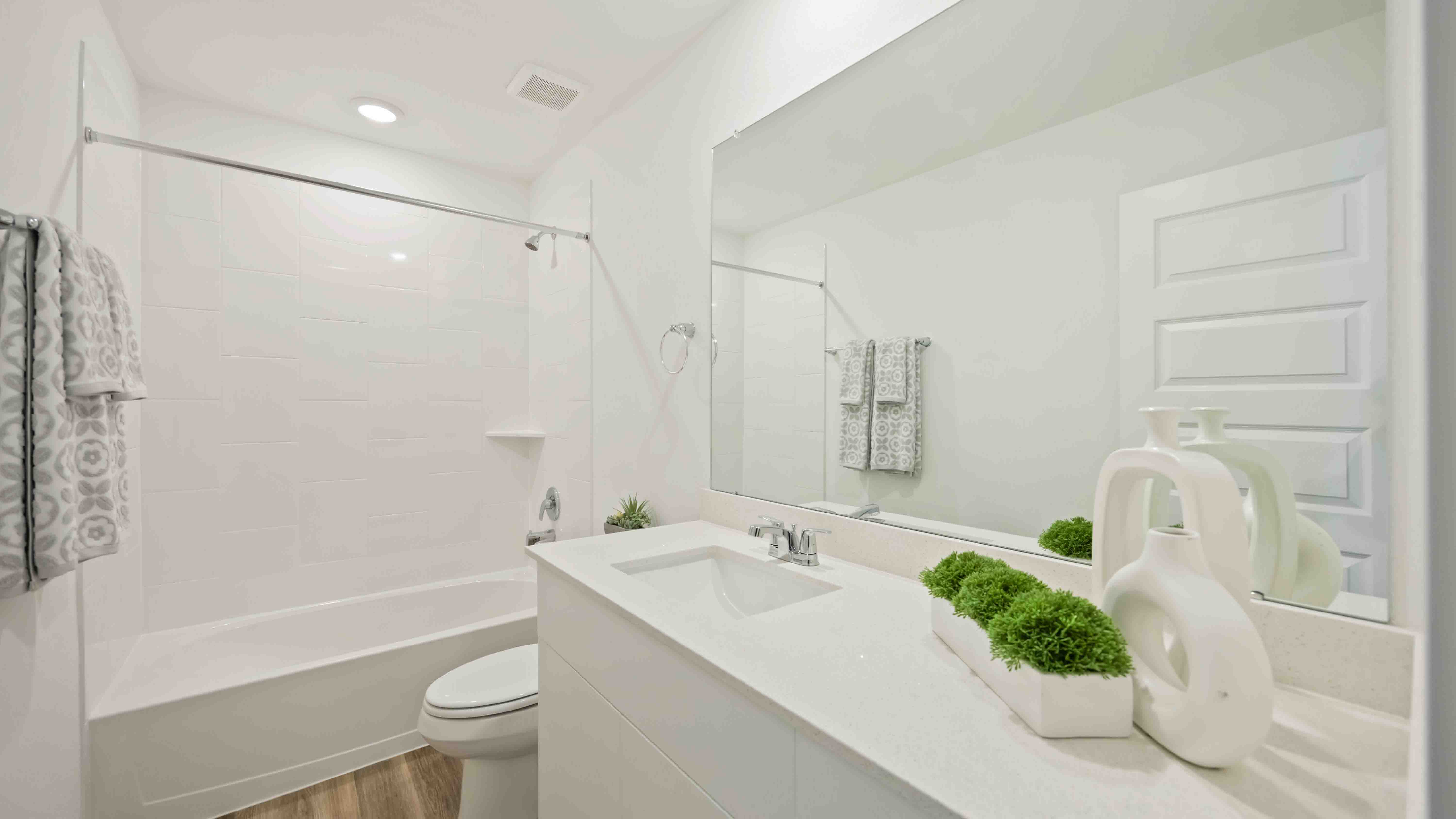 a spacious secondary bathroom with one sink vanity and standing tub