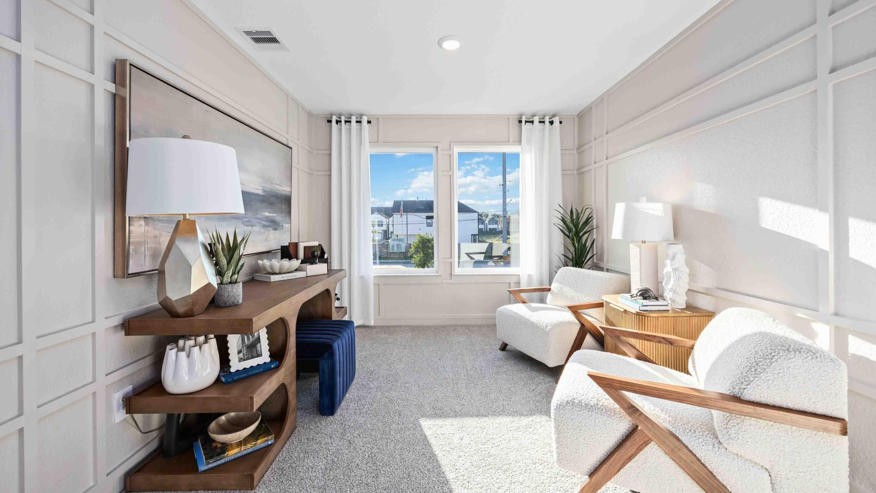 spacious upstairs living area with plenty of natural light from windows overlooking side of the home