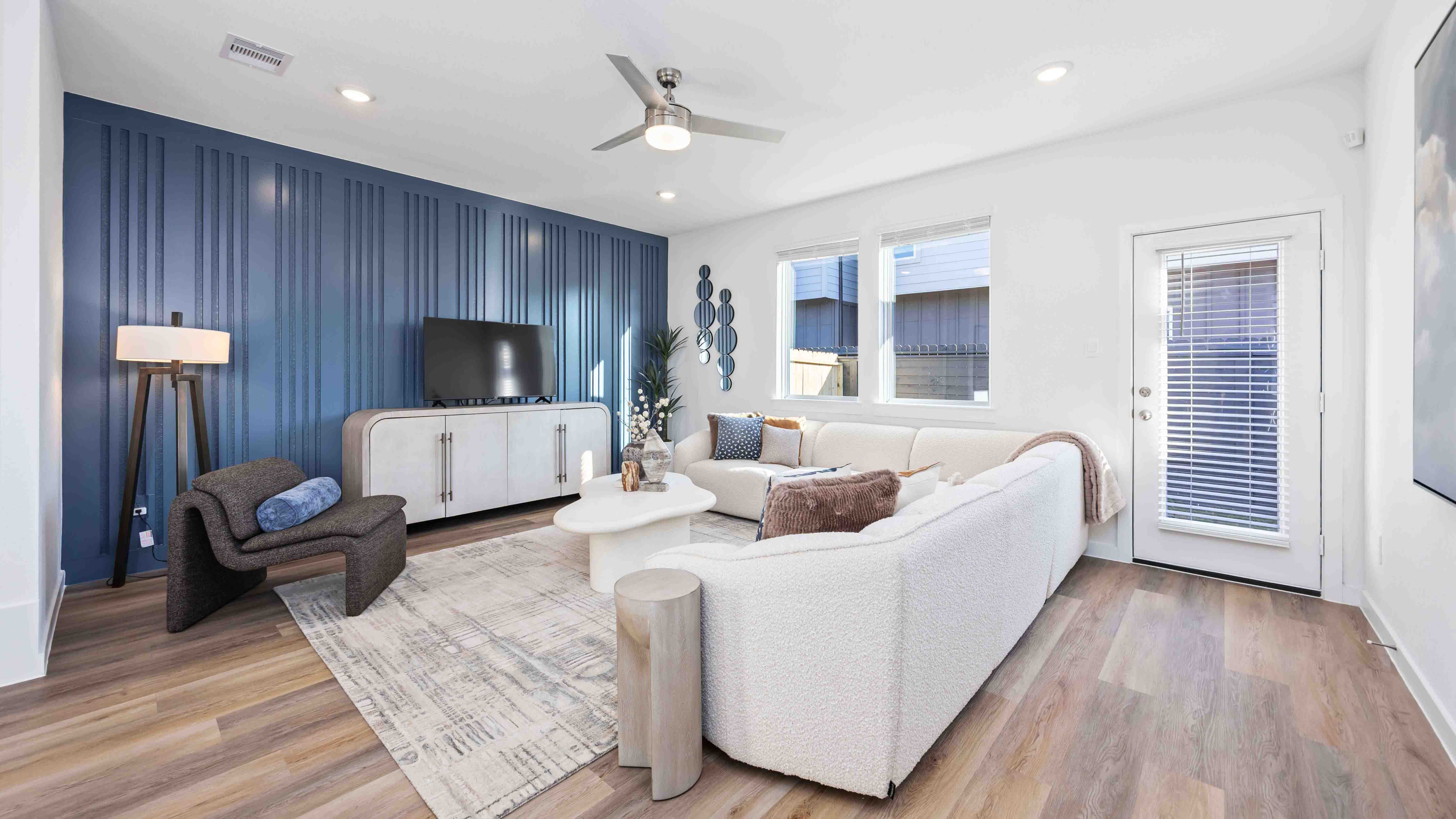 spacious living room with plenty of natural light from windows overlooking the backyard