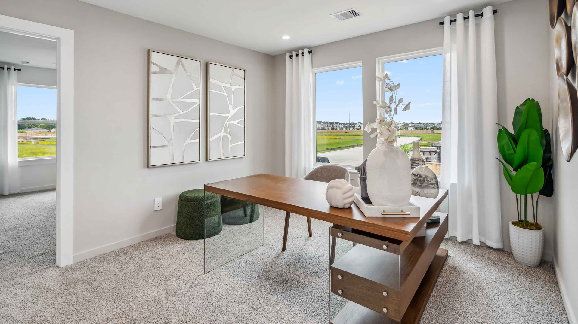spacious upstairs living area with plenty of natural light from windows overlooking side of the home