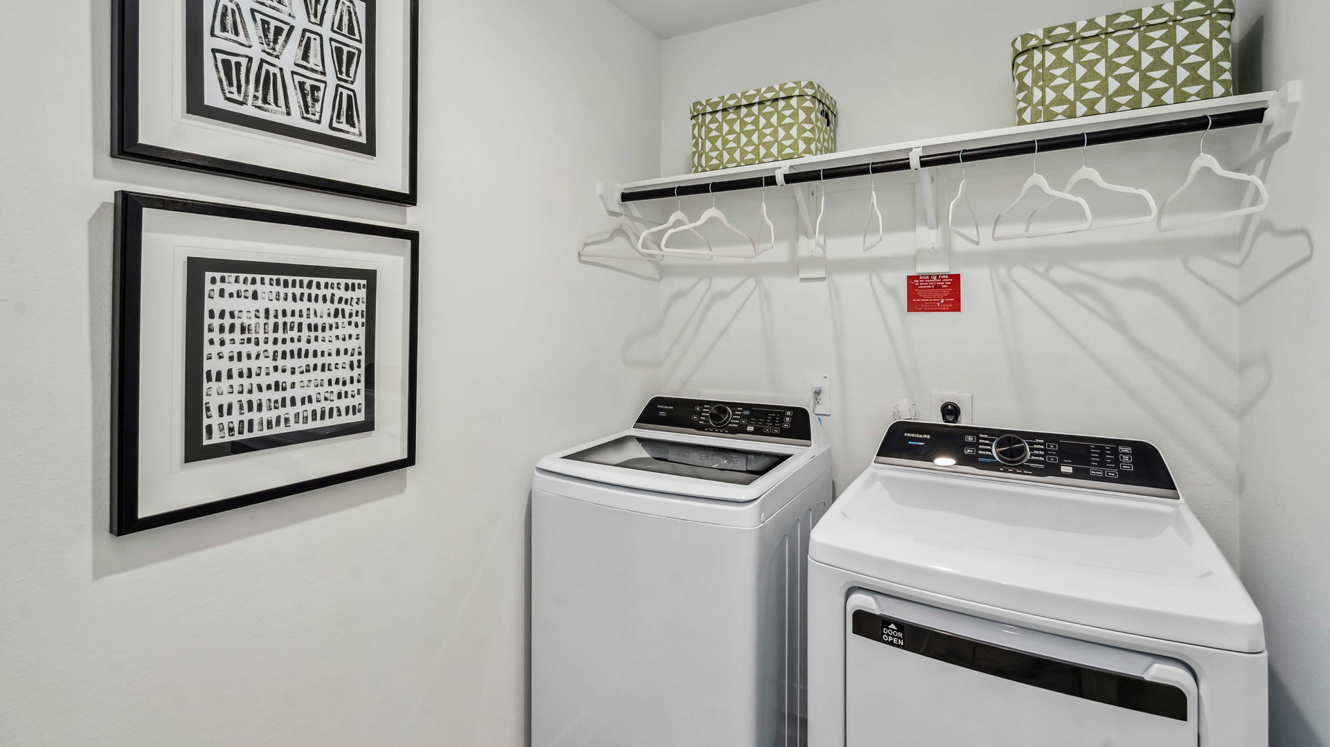laundry room area with an open shelf and rod for additional storage and hanging clothes
