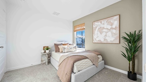 secondary bedroom which has a large window for natural lighting