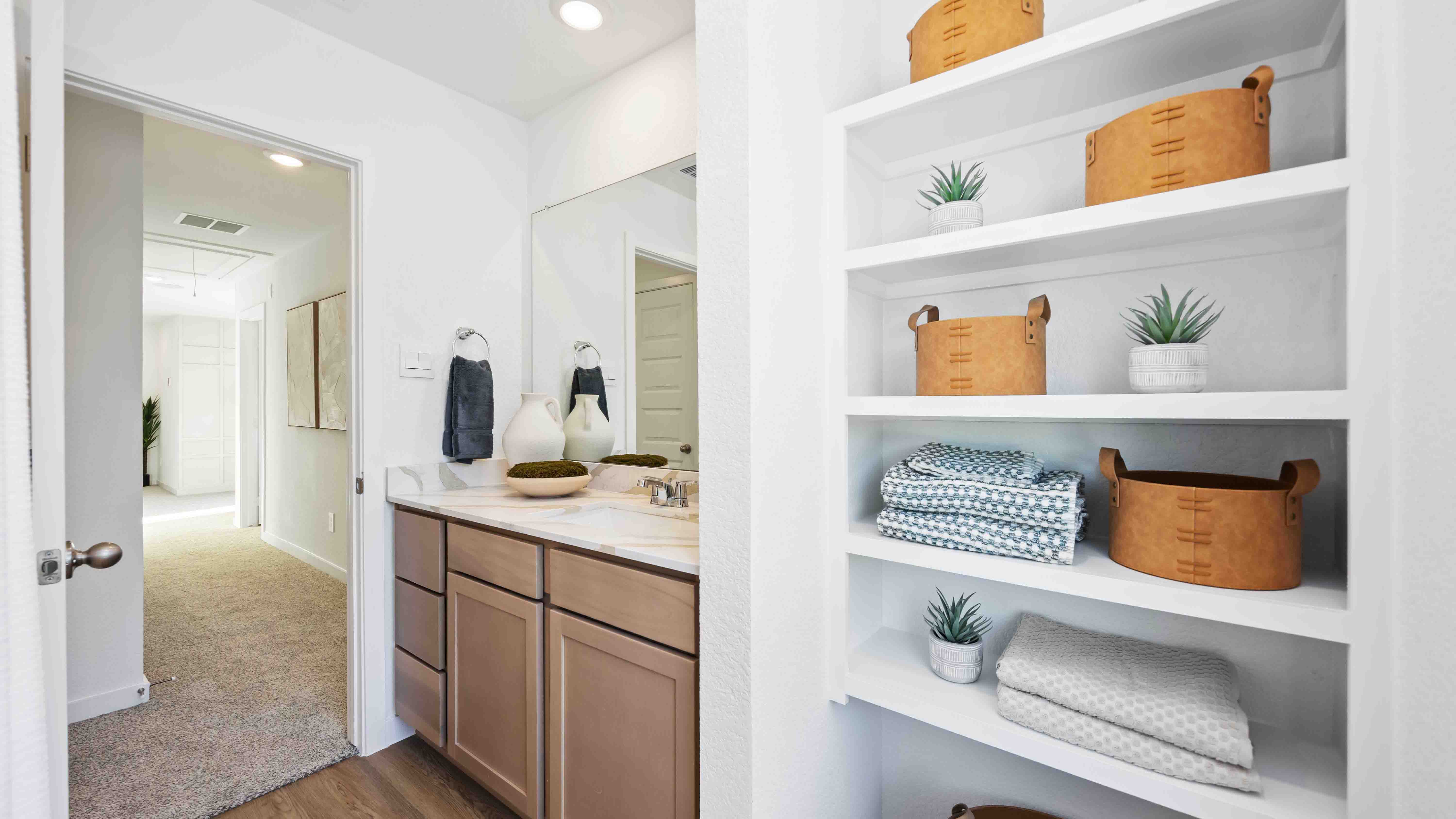 secondary bathroom with shelving storage