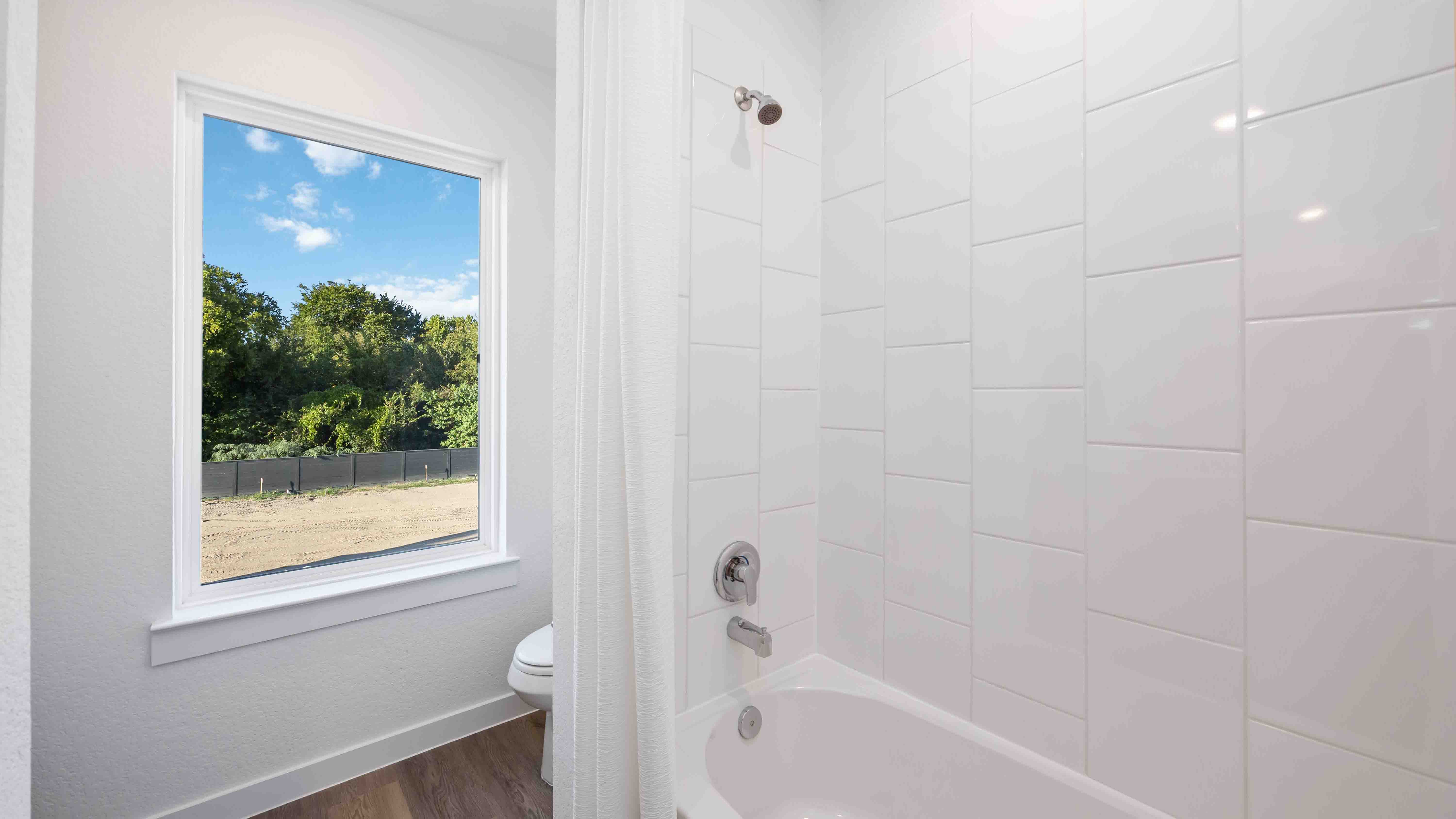 secondary bathroom with a large window for natural lighting