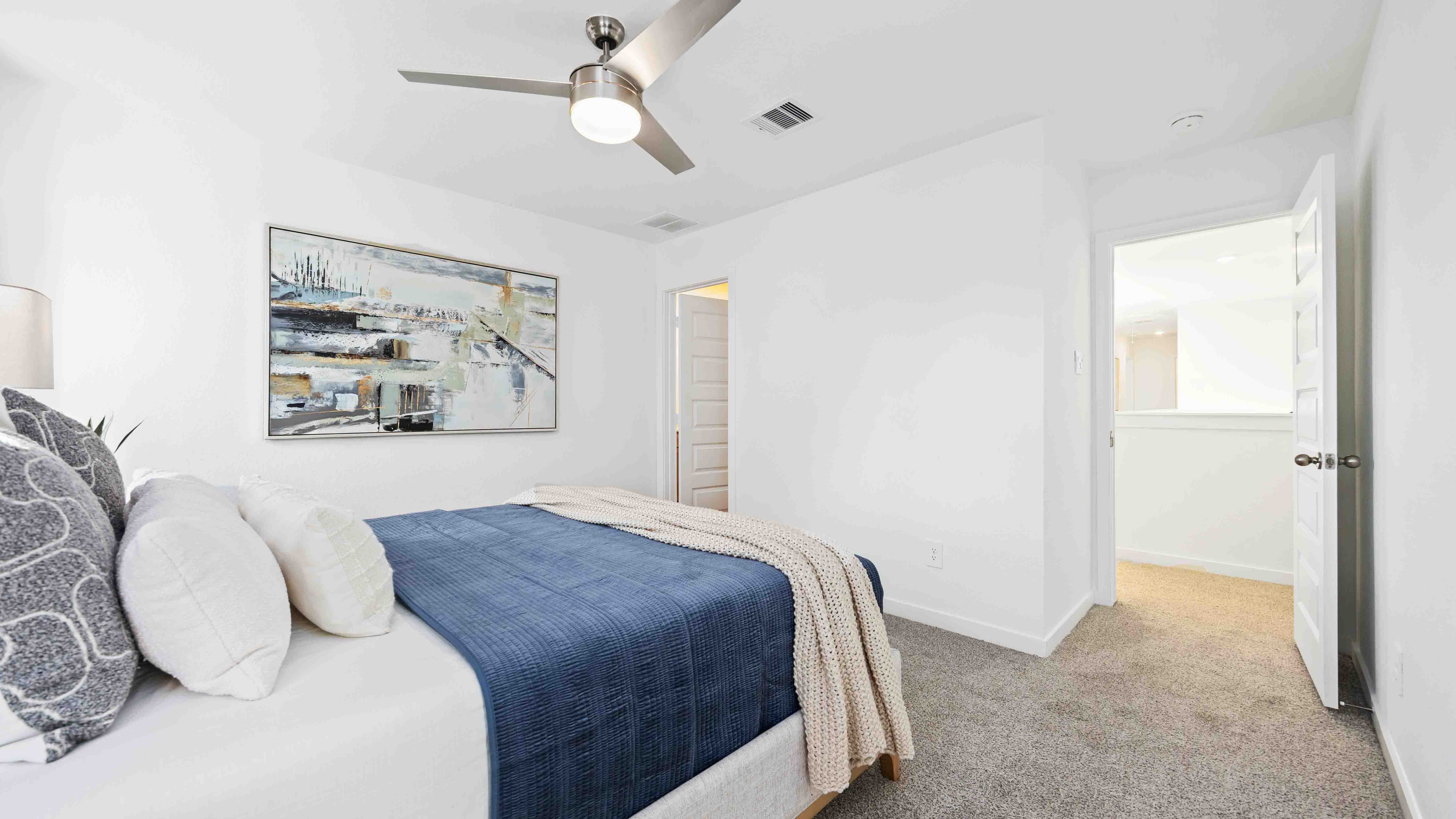 primary bedroom with a ceiling fan and enough space for a queen bed and side tables