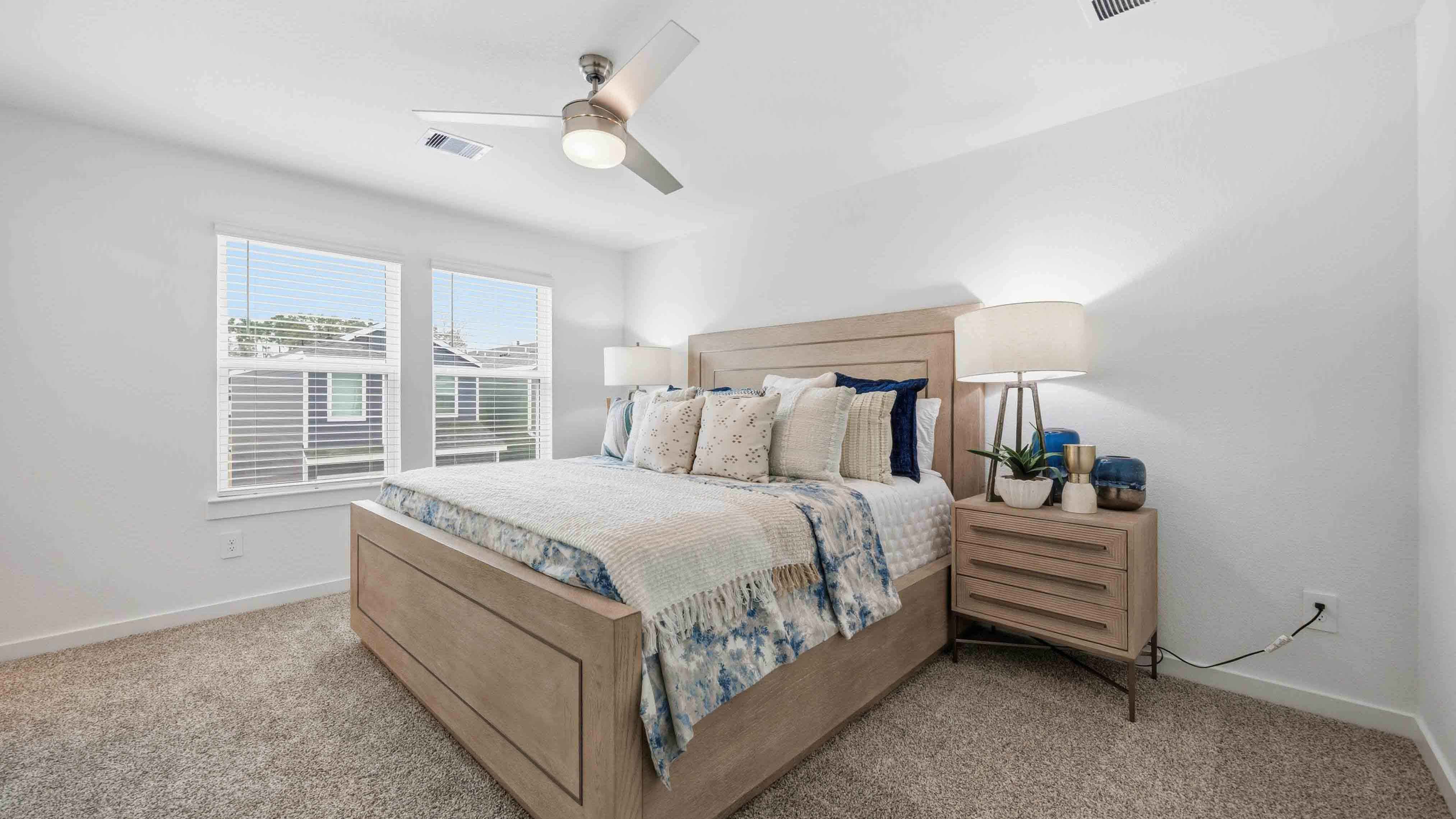 a spacious primary suite comfortably fits a king size bed and additional bedroom furniture