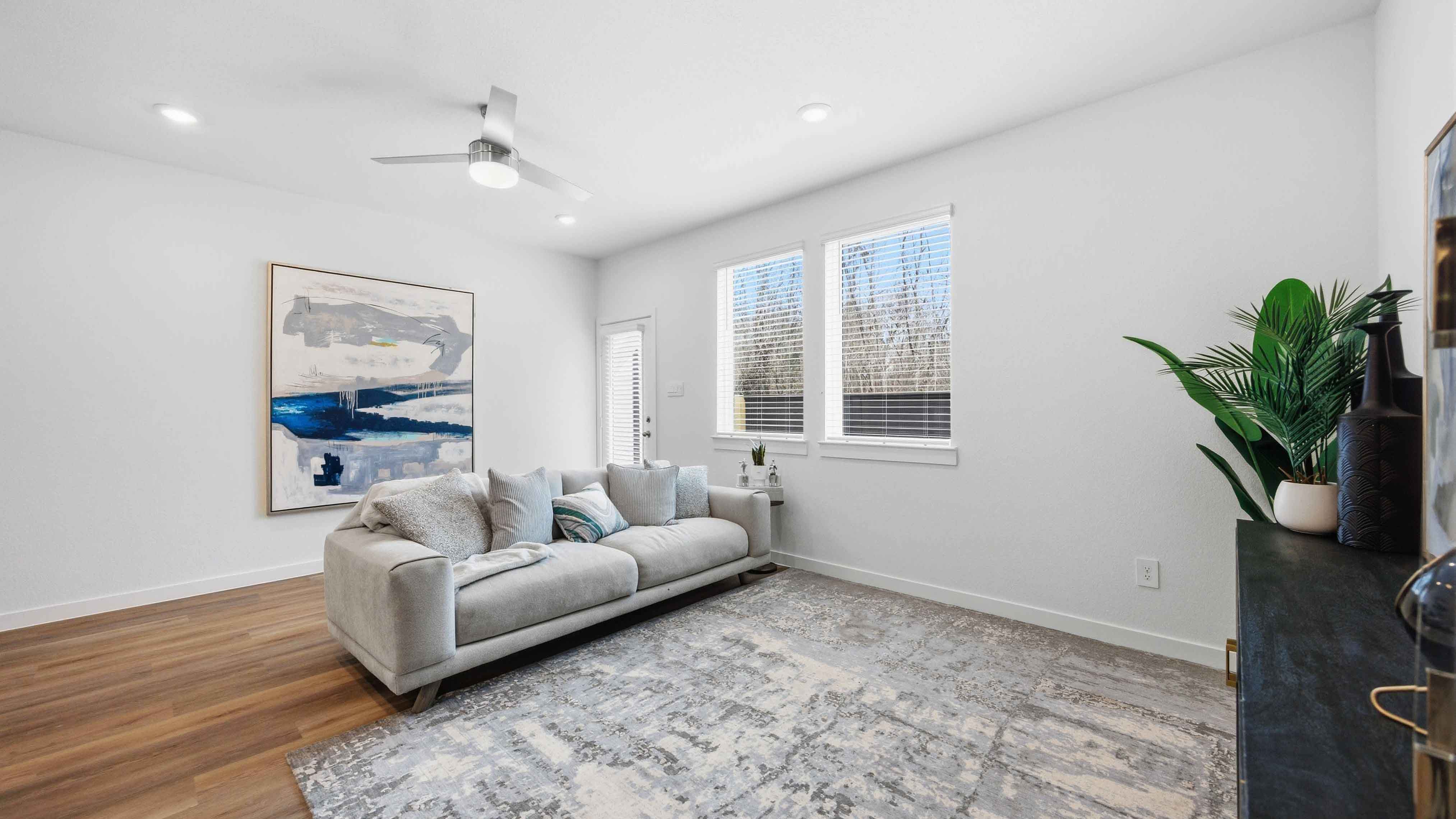 living room area with two large windows to the backyard