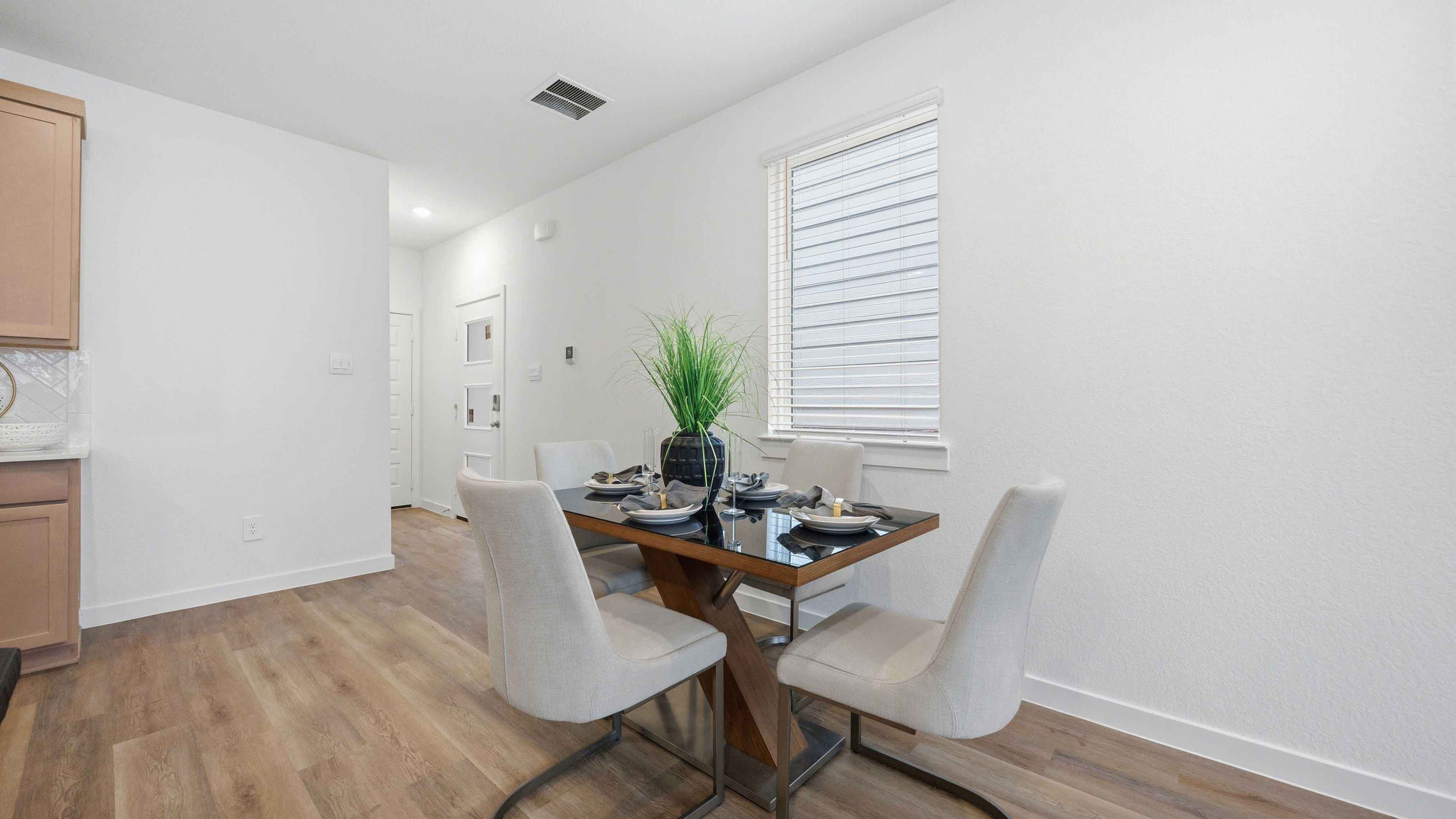 dining area with natural lighting that overlooks the backyard