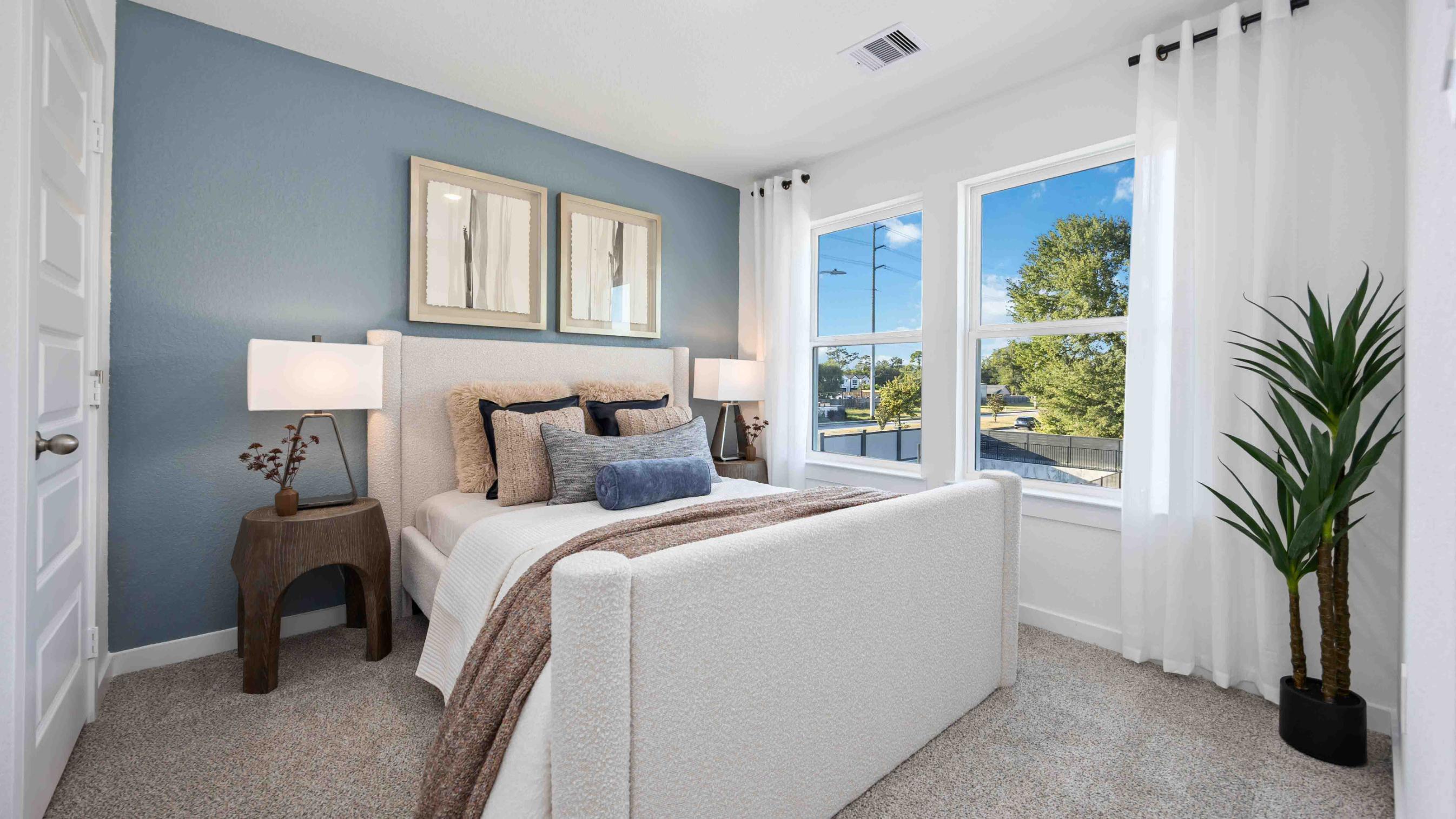 third bedroom has light neutral walls, plush carpet flooring, and a walk-in closet