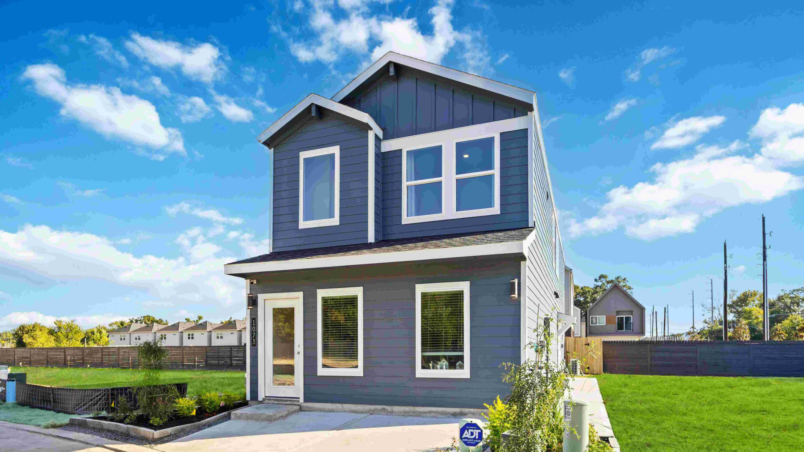 beautiful two story home with siding, large exterior windows for natural lighting and a side entry for privacy