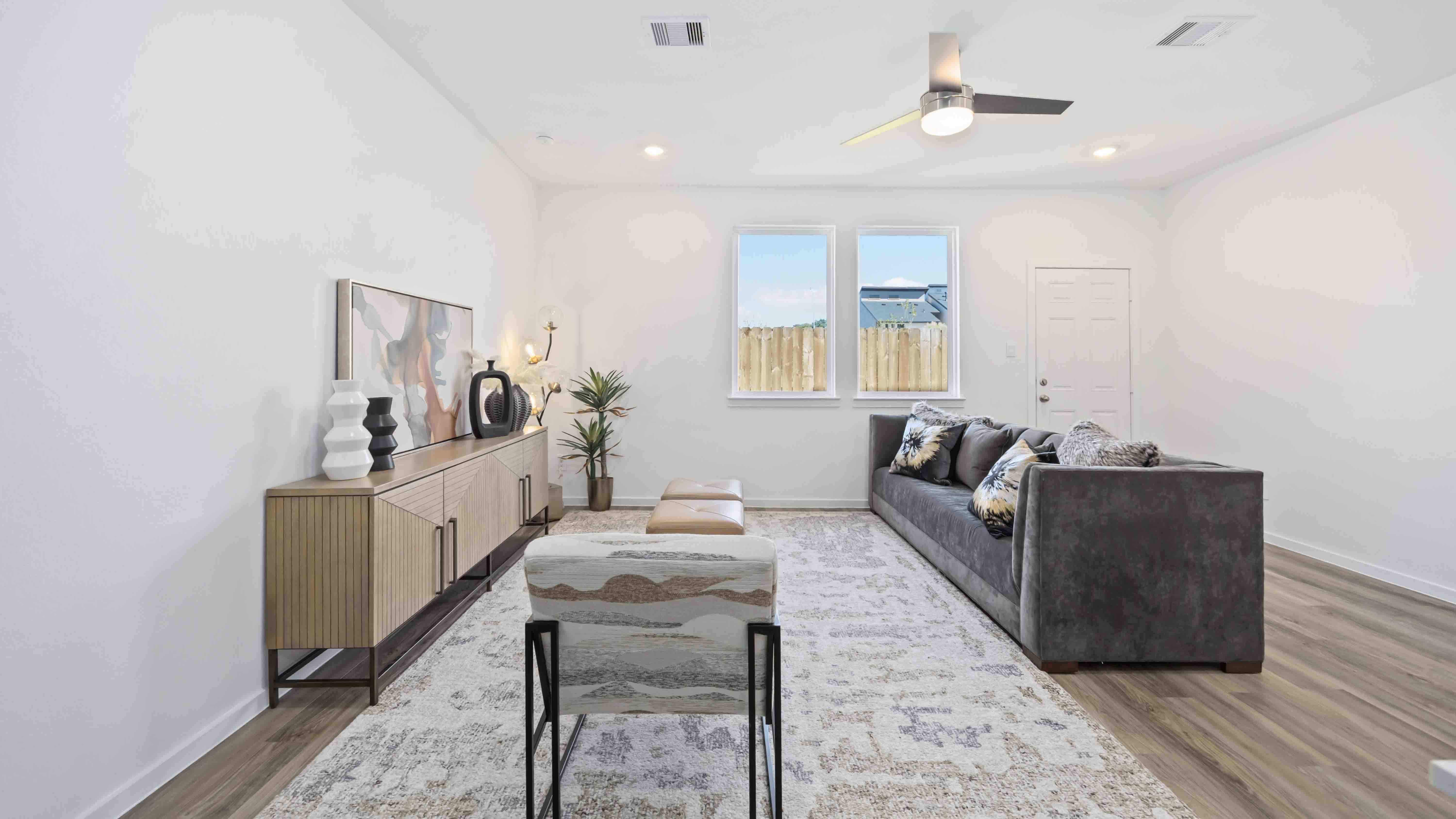 living room area with two large windows to the backyard