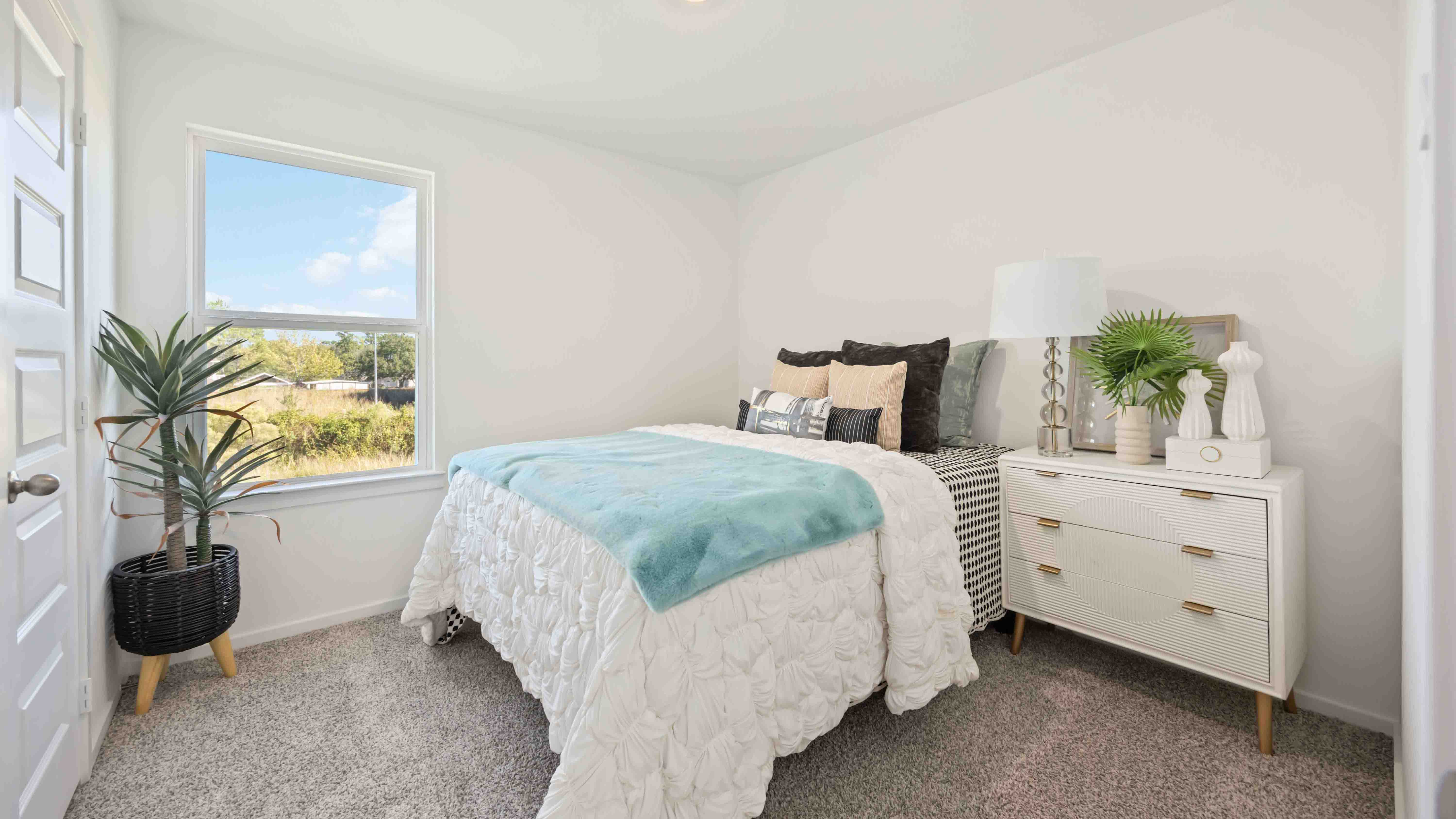 secondary bedrooms have light neutral walls and carpet flooring
