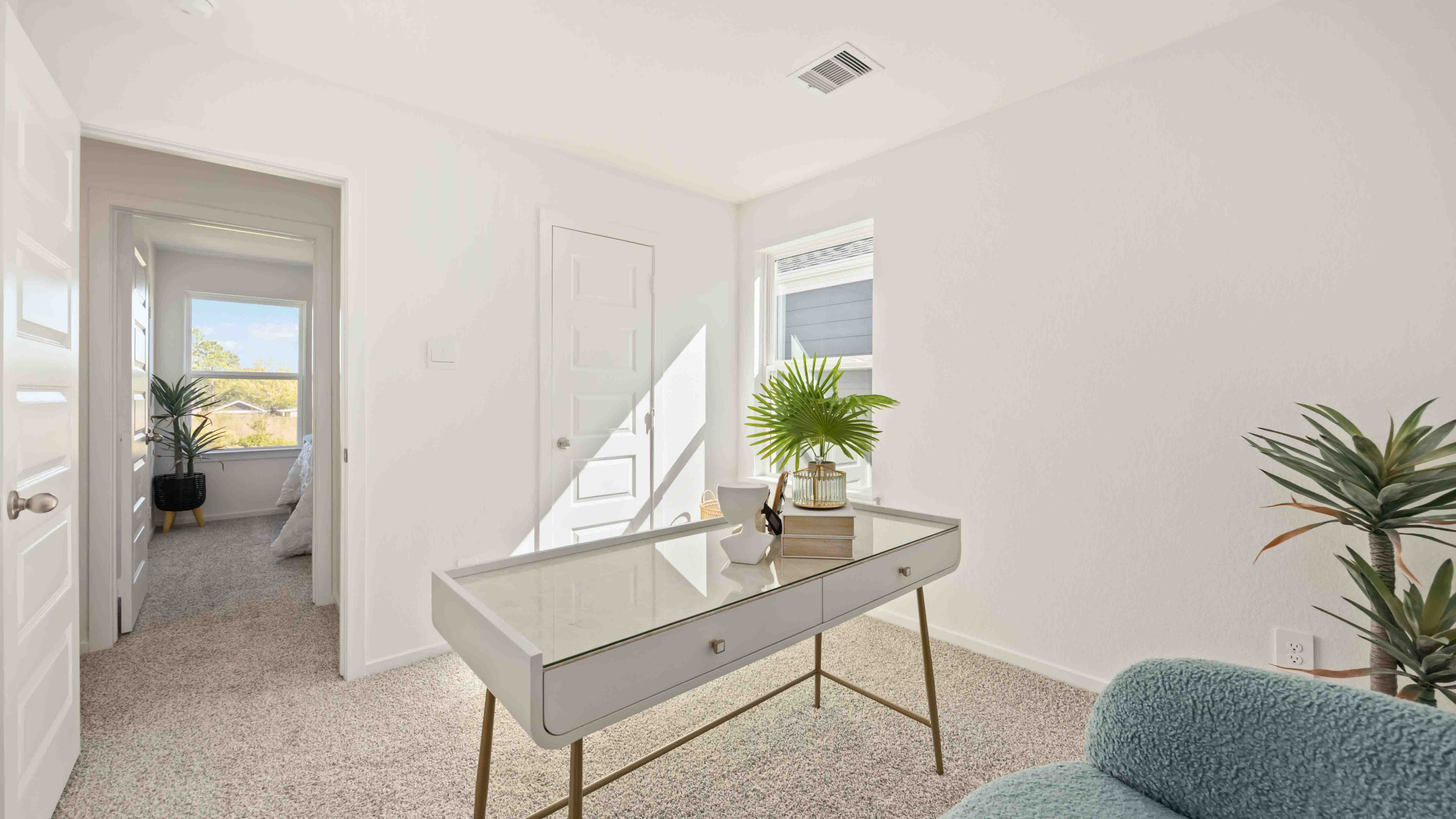 spacious upstairs living area with plenty of natural light from windows overlooking side of the home