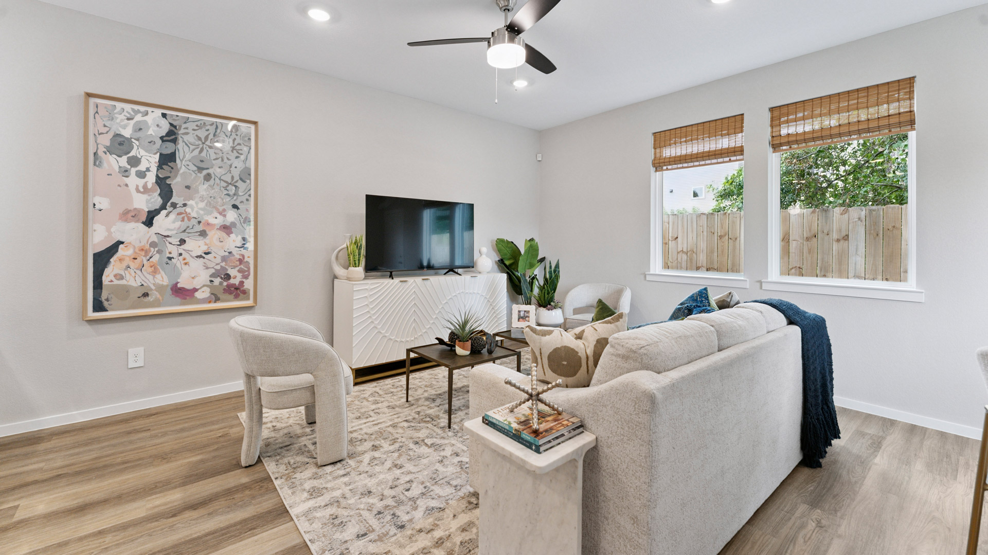 spacious living room with plenty of natural light from windows overlooking the backyard