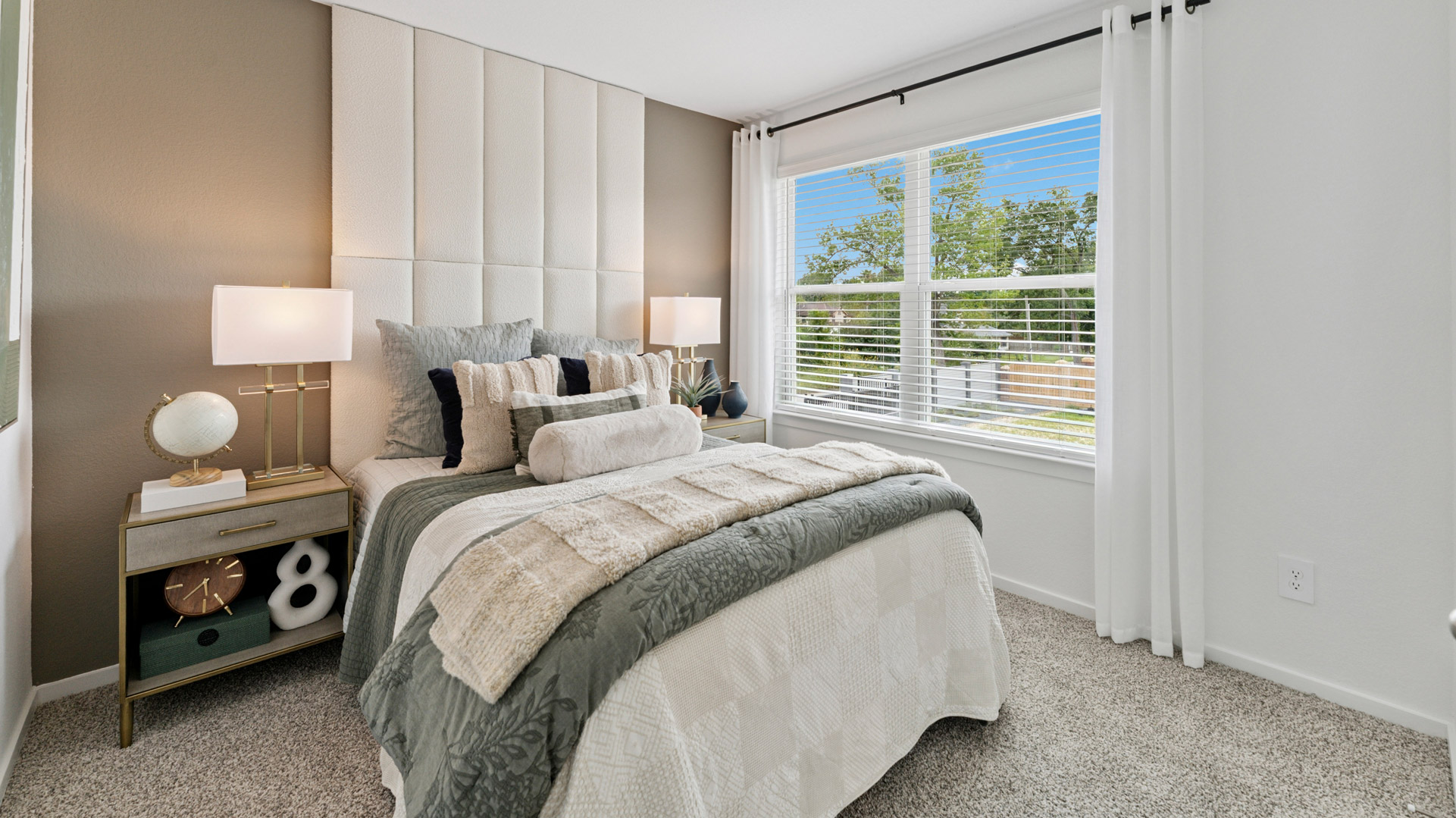 secondary bedrooms have light neutral walls and carpet flooring