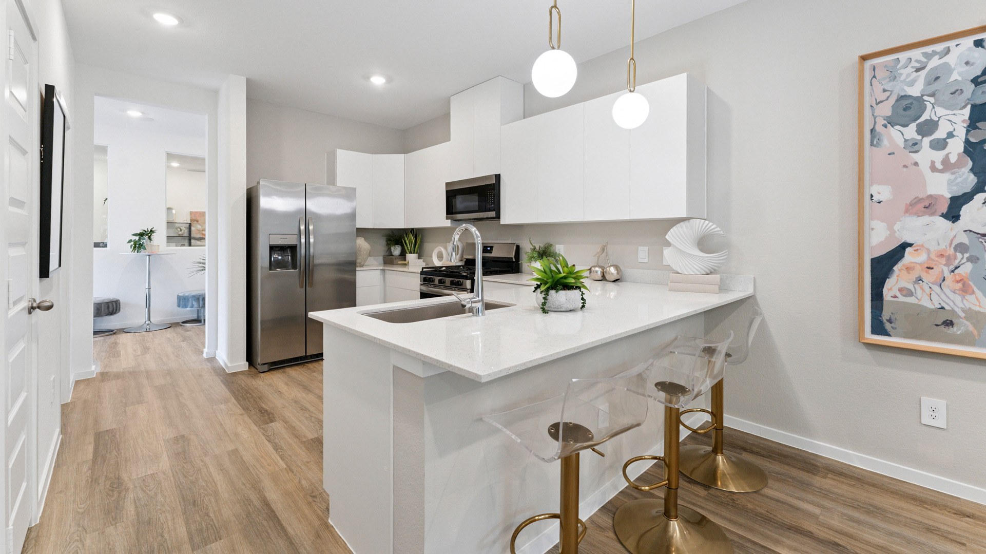 beautiful new kitchen with quartz counters and white cabinets