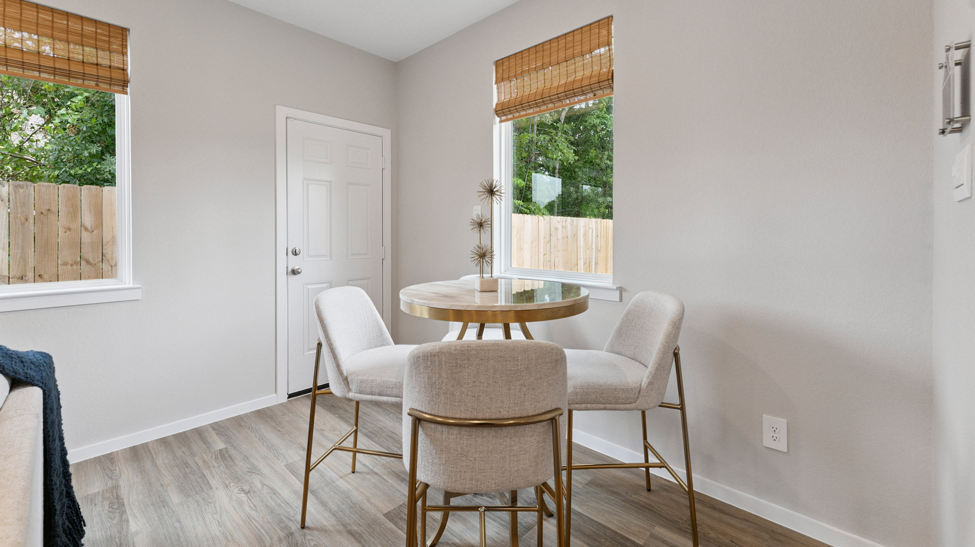 dining area with vinyl wood flooring, large window and tall ceiling