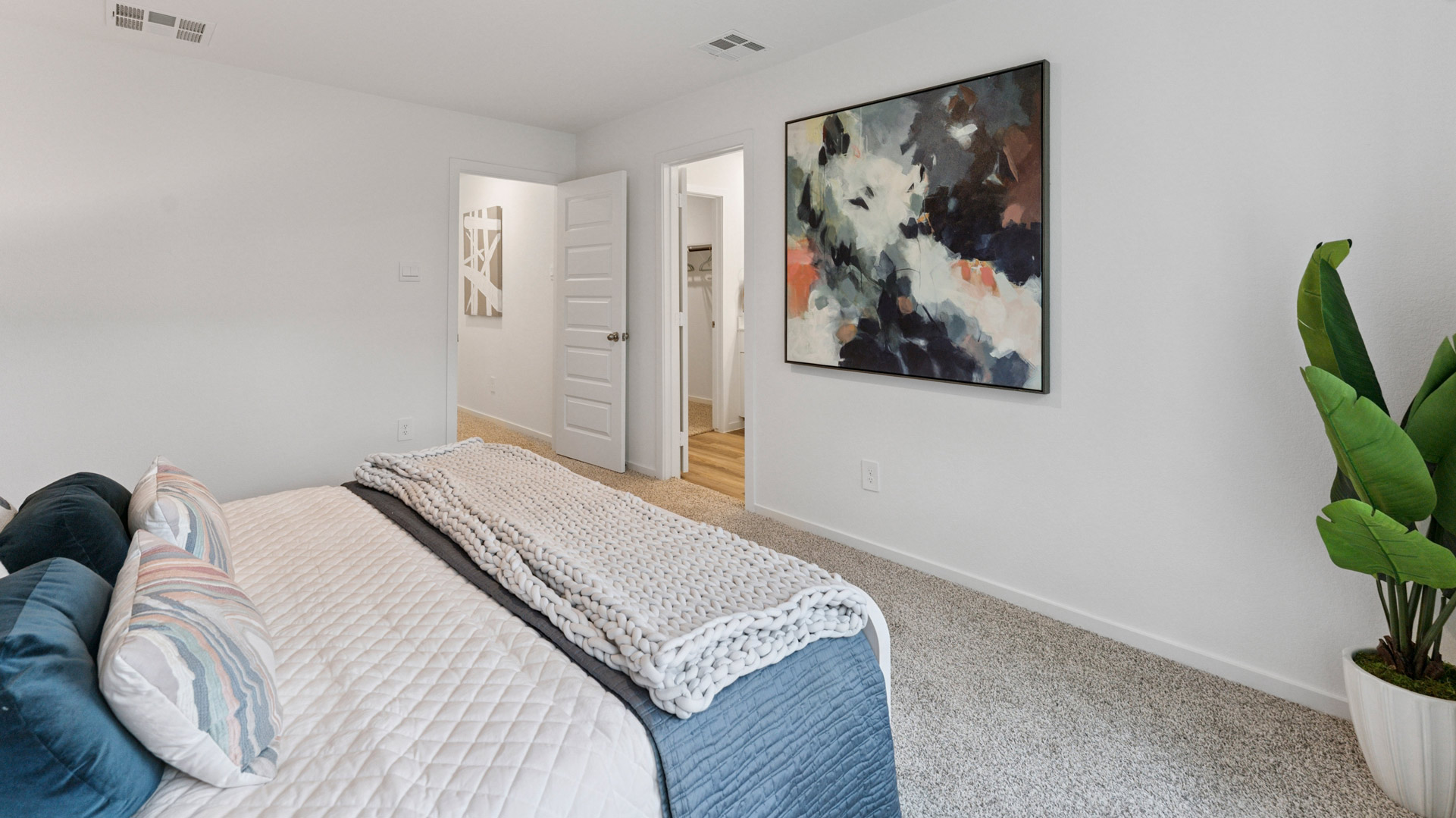 the spacious primary bedroom comfortably fits a king size bed