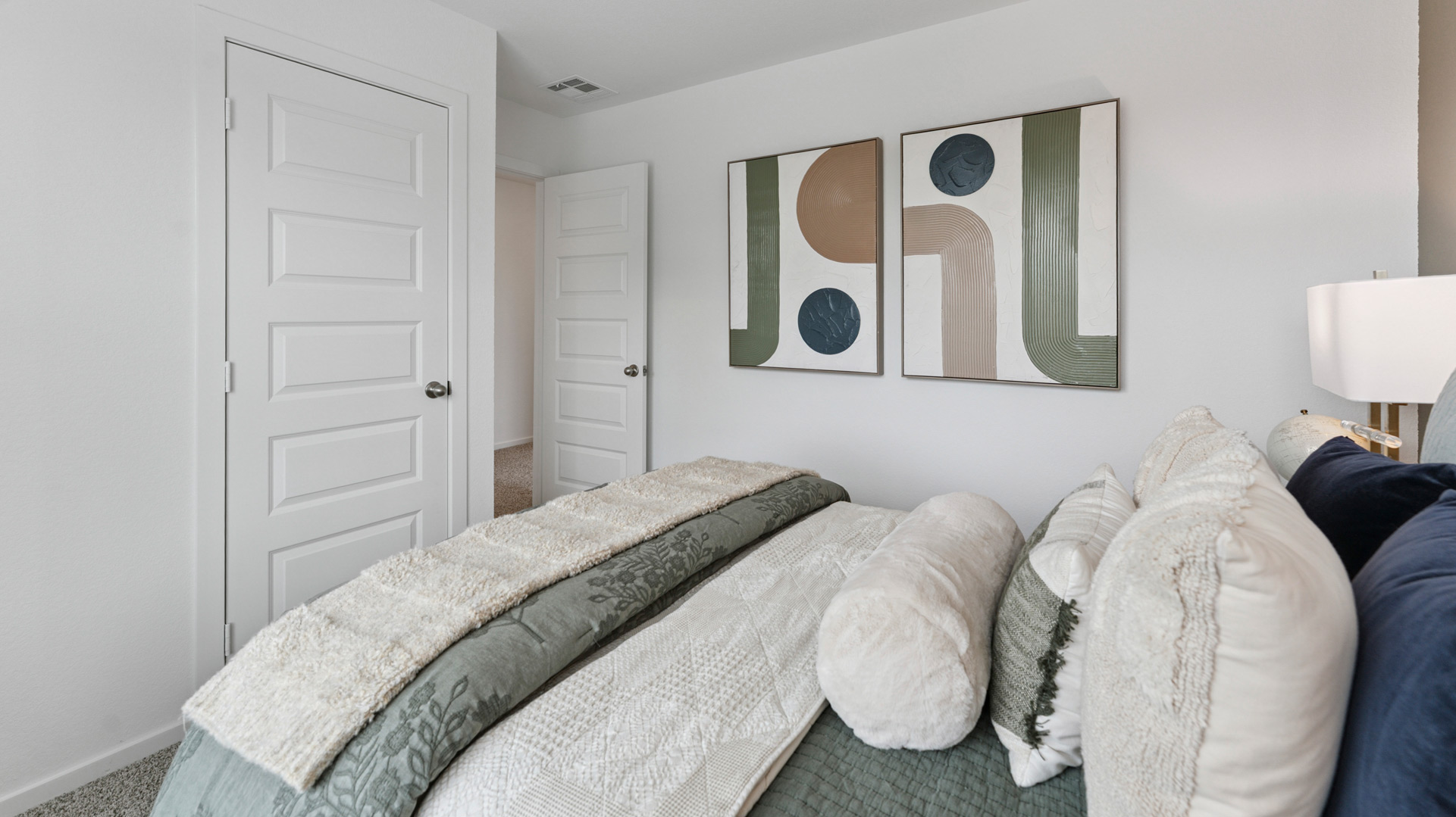 the third bedroom, located upstairs, has carpet flooring and light neutral walls
