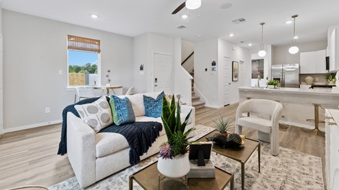 the living room, dining area, kitchen, and a powder bath are all located on the main floor
