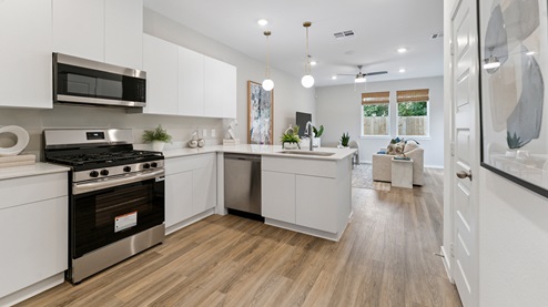 the kitchen overlooks all main living areas of the home