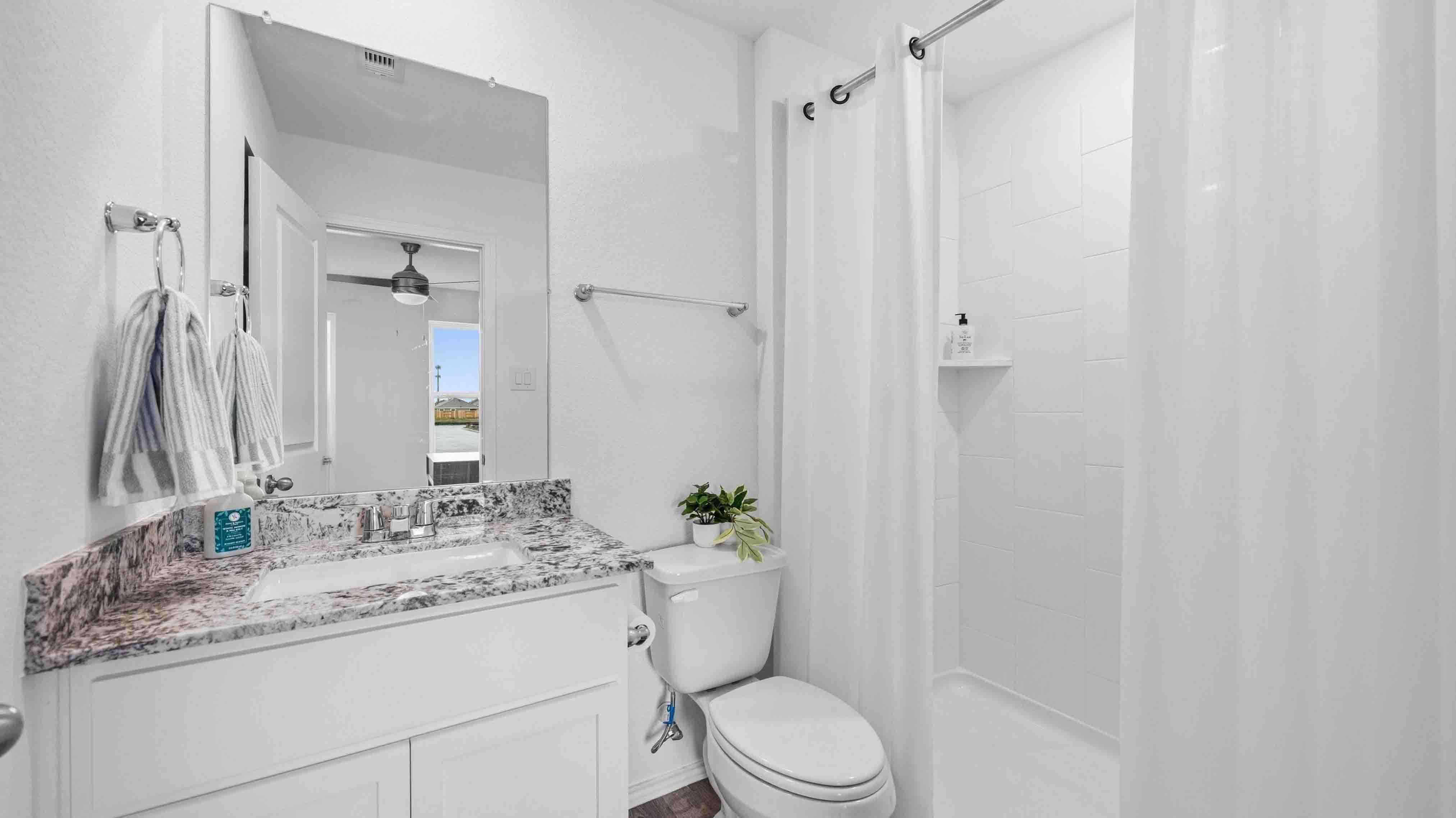 secondary bathroom with a standing tub